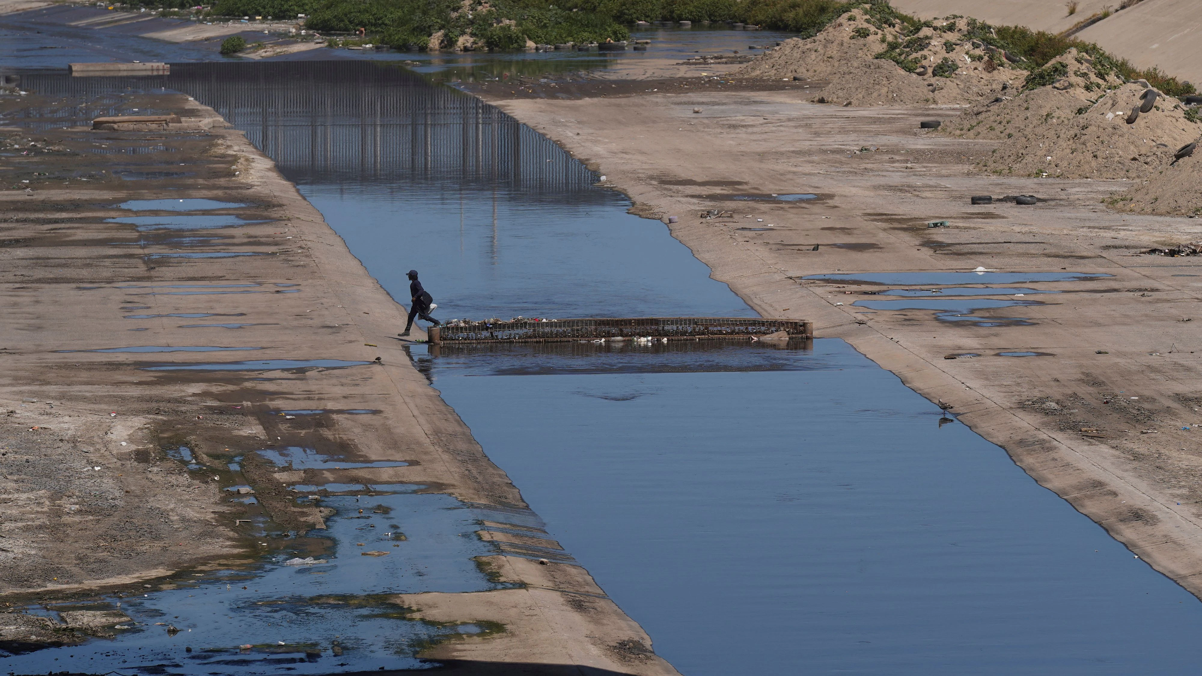 A person walks over the Tijuana River, as the Iranian national soccer team is set to establish its base camp for the FIFA World Cup 2026 in Tijuana after Mexico’s President Claudia Sheinbaum agreed to host the squad, following reports that the U.S. government did not want Iran to remain at its original base in Arizona during the tournament, in Tijuana, Mexico, May 30, 2026. REUTERS/Victor Medina