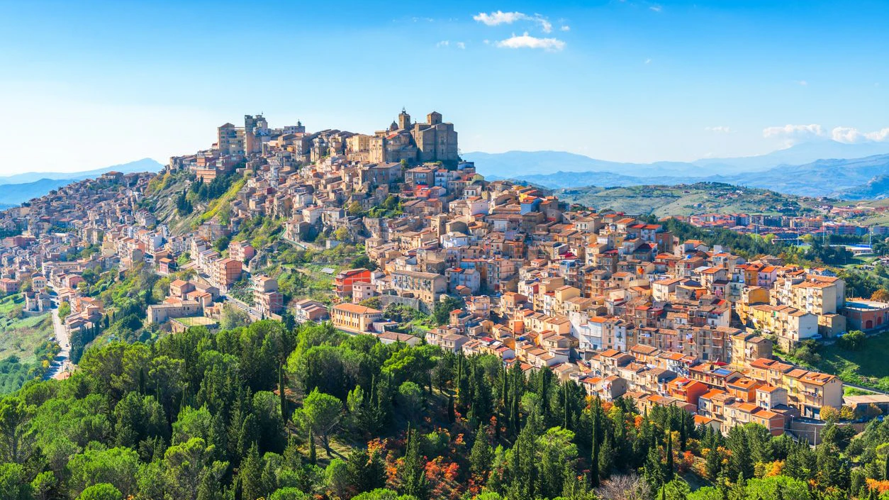 Troina, Sicily, Italy hilltop townscape above the trees.