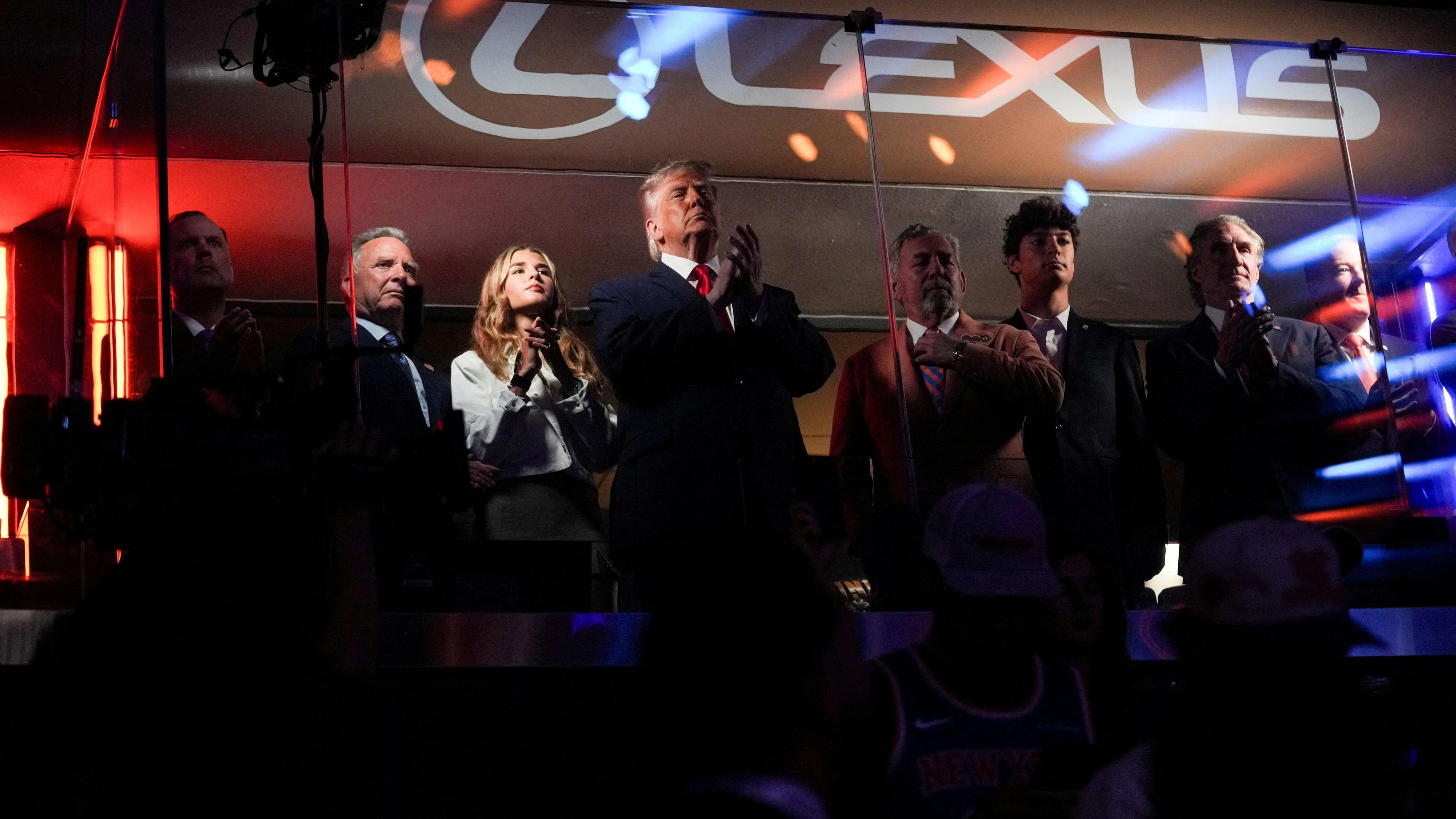U.S. President Donald Trump applauds as he attends Game 3 of the NBA Finals, alongside his granddaughter Kai Trump and New York Knicks owner James Dolan, at Madison Square Garden in New York City, New York, U.S., June 8, 2026. REUTERS/Nathan Howard REFILE - CORRECTING FROM "NBA PLAYOFFS" TO "NBA FINALS".