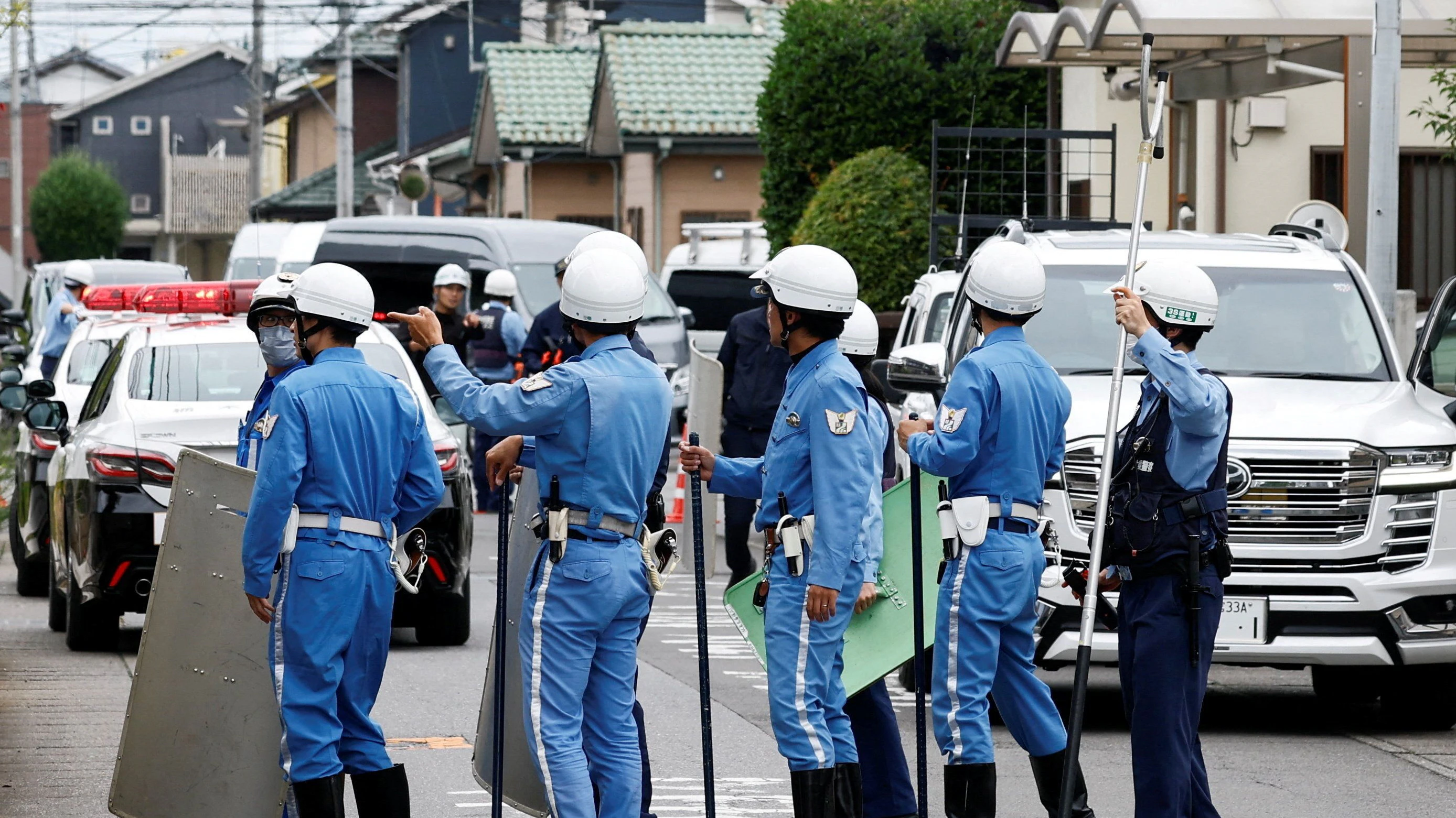 Police officers with shields and sticks search for a bear at a residential area after a black bear was spotted in Utsunomiya, Tochigi Prefecture, Japan, June 9, 2026. REUTERS/Kim Kyung-Hoon  