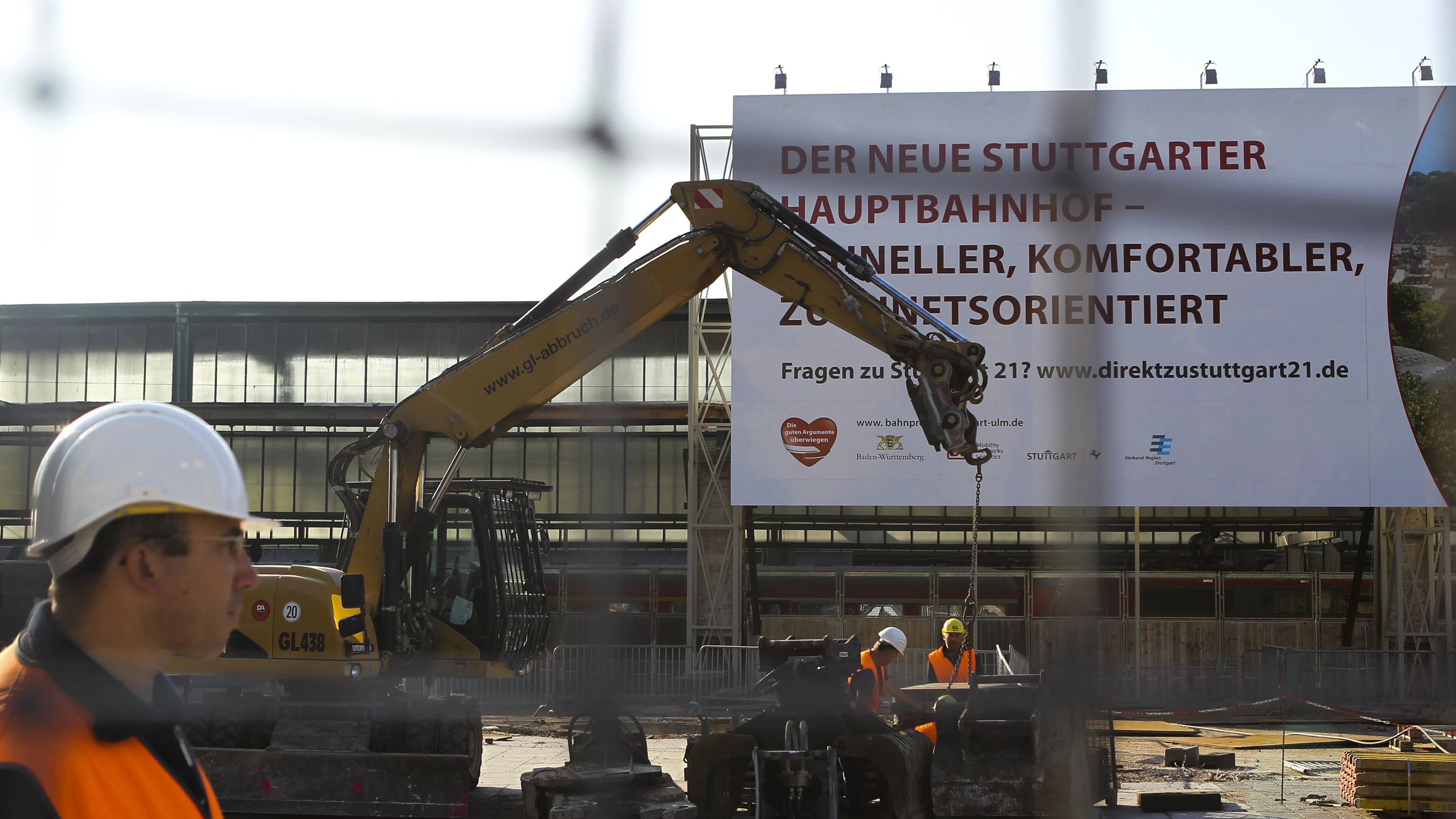 An excavator works in front of the Stuttgart train station, June 15, 2011. German rail operator Deutsche Bahn restarted work on the controversial Stuttgart 21 rail project on Tuesday. The project involves rebuilding the city's historical main station to make way for the Stuttgart 21 underground railway station. REUTERS/Alex Domanski (GERMANY - Tags: POLITICS TRANSPORT)