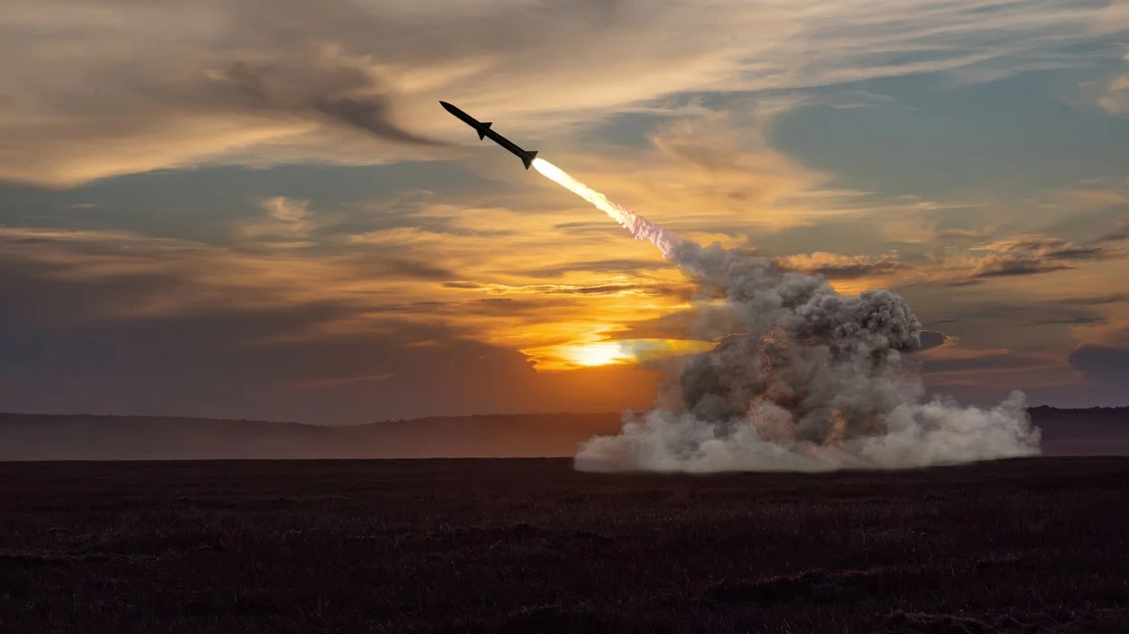 rocket launch against the background of the evening field, the setting sun.