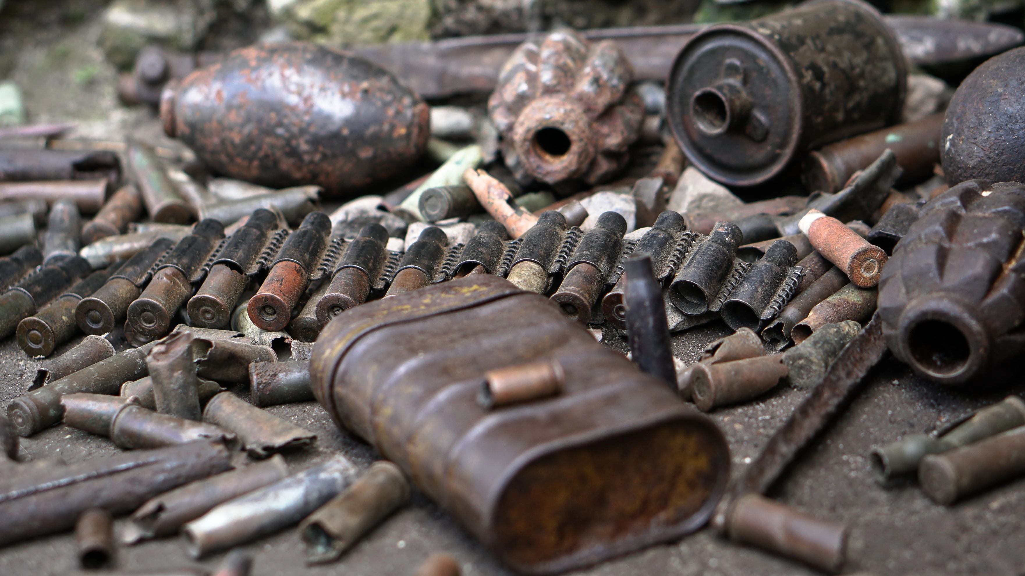 Military background with cartridges of grenades and machine-gun tape. Black archeology. World War II and its artifacts. Great Patriotic War of the USSR