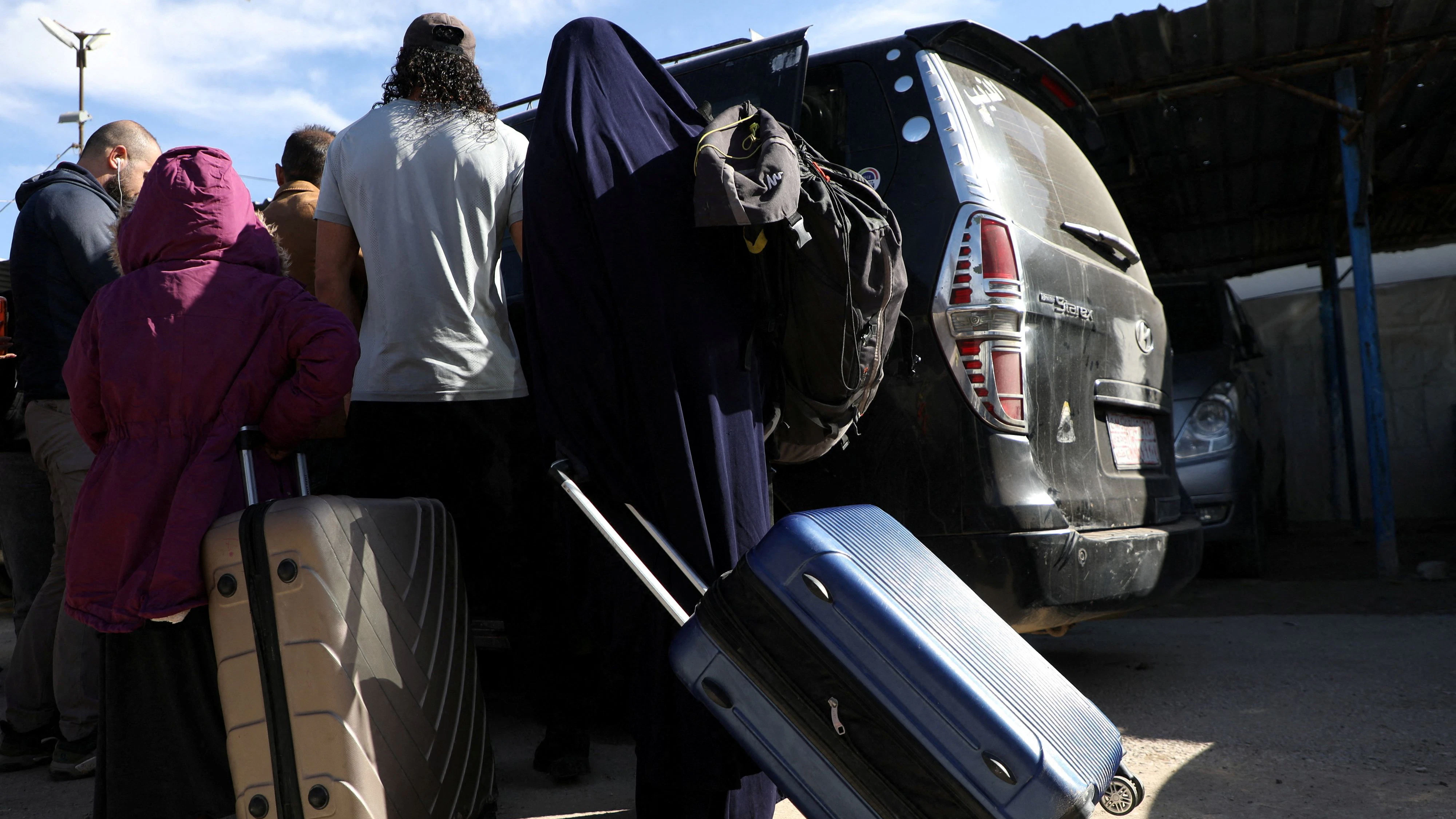 Members of Australian families believed to be linked to the Islamic State militants leave Roj camp near Derik, Syria February 16, 2026. The families later returned to the detention center due to "technical reasons," two sources told Reuters. REUTERS/Orhan Qereman REFILE - ADDING INFORMATION