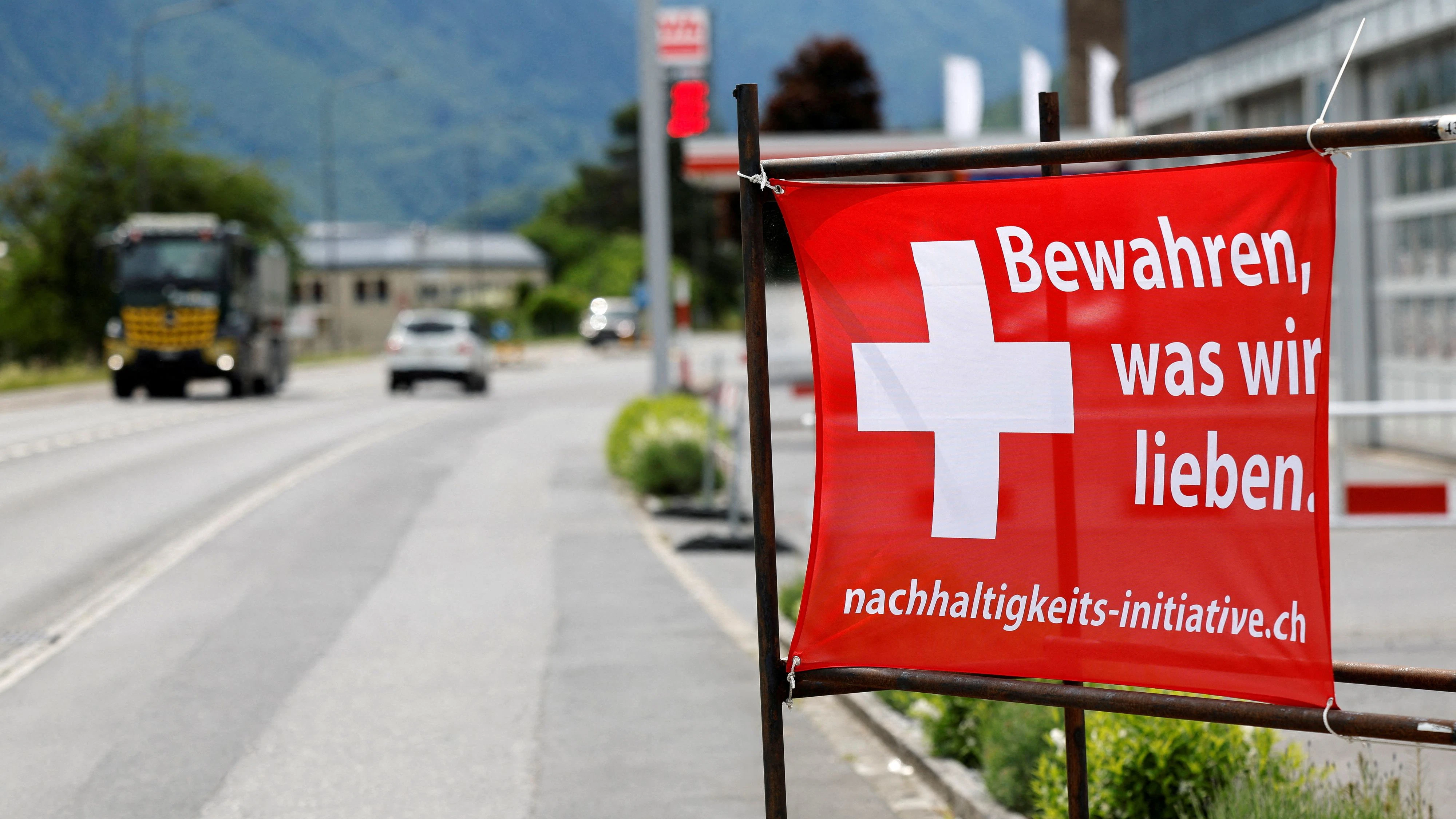 A sign is pictured ahead of a June 14 vote on a plan backed by the right-wing Swiss People's Party (SVP) to cap the population at 10 million inhabitants, in Glarus, Switzerland, May 18, 2026. The sign reads: "Preserve what we love". REUTERS/Stefan Wermuth REFILE - CORRECTING TRANSLATION FROM "PRESERVE WHAT WE HAVE" TO "PRESERVE WHAT WE LOVE".   