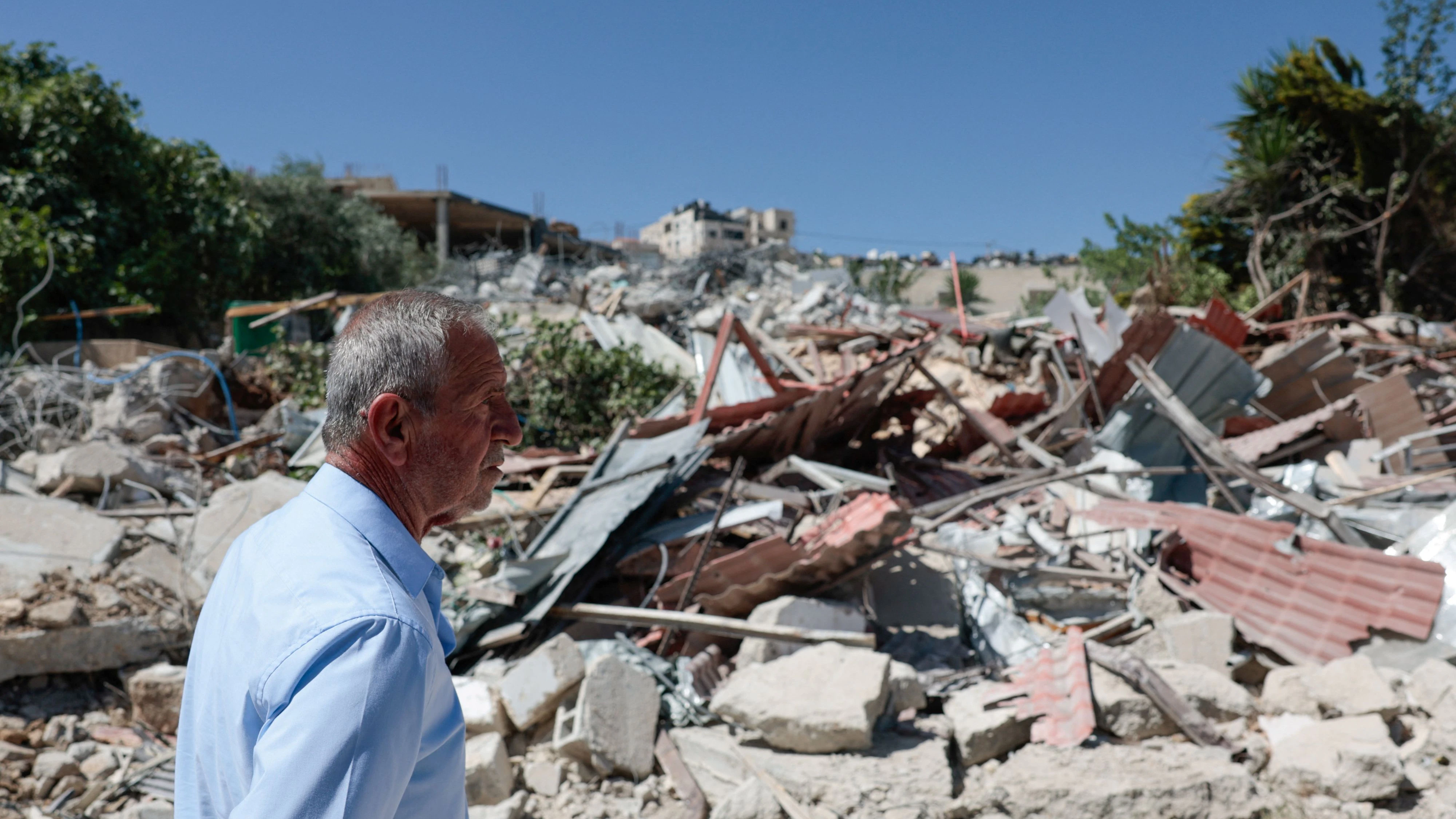 A man walks past the rubble of a Palestinian building demolished by Israeli military in the town of Jabaa in the Israeli-occupied West Bank, near Jerusalem  June 3, 2026. REUTERS/Mohammed Torokman