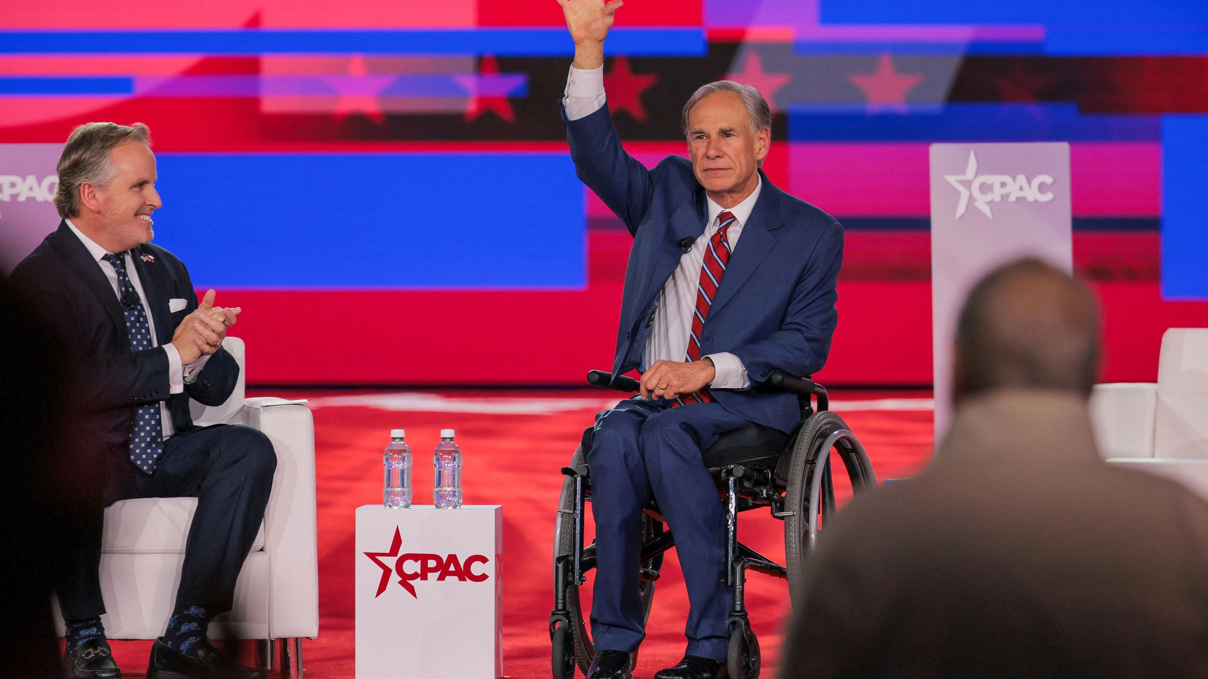 U.S. Senator (R-TX) Bryan Hughes and Governor of Texas Greg Abbott attend the Conservative Political Action Conference (CPAC) USA 2026 at the Gaylord Texan Resort and Convention Center, in Grapevine, Texas, U.S., March 27, 2026.  REUTERS/Daniel Cole   