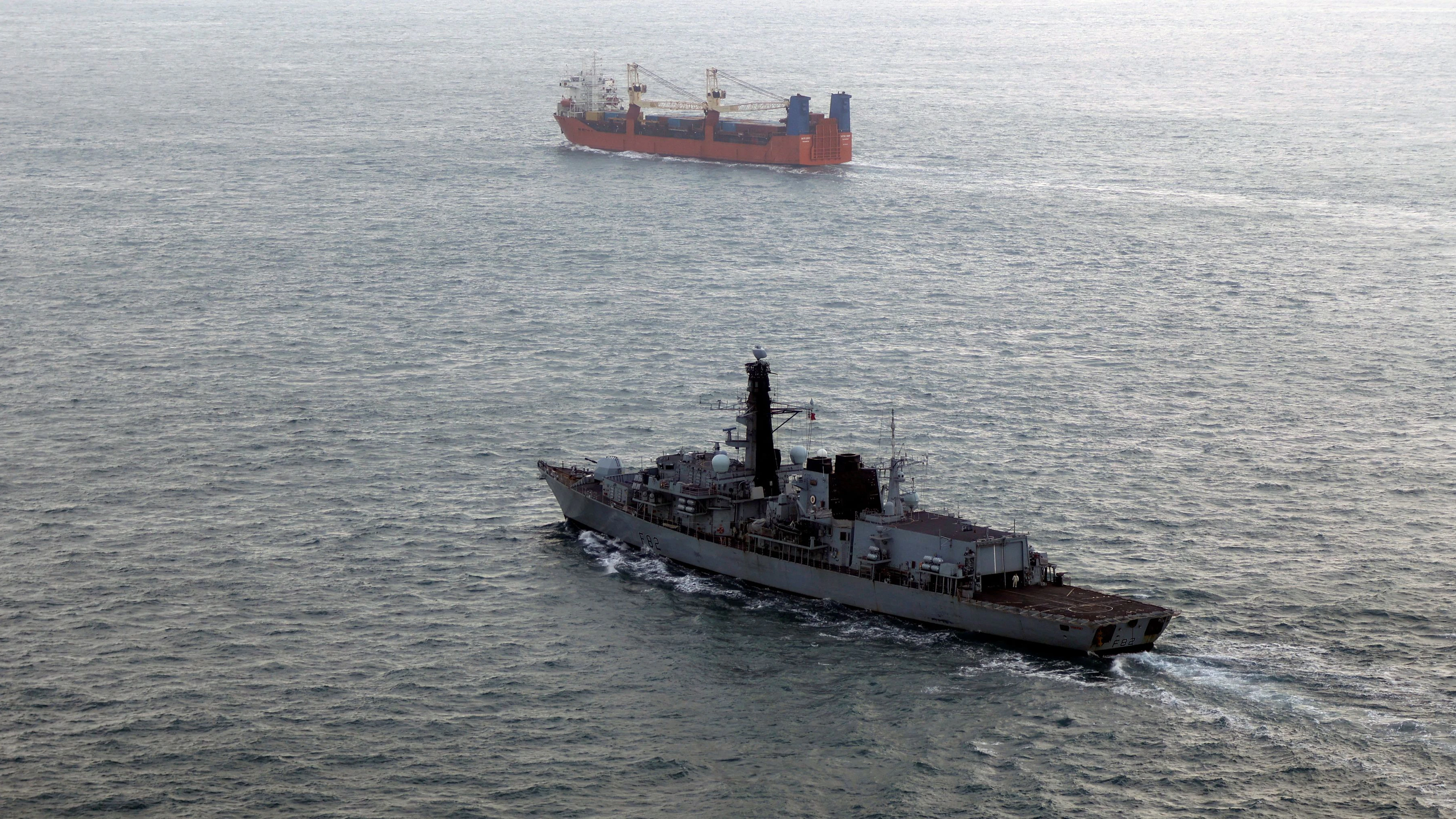 Royal Navy frigate HMS Somerset monitors merchant vessel Baltic Leader, which the Royal Navy said, was escorted by the Russia's Boikiy warship through UK waters, as part of a 3-day operation, in this undated handout image. Royan Navy/Handout via REUTERS    THIS IMAGE HAS BEEN SUPPLIED BY A THIRD PARTY