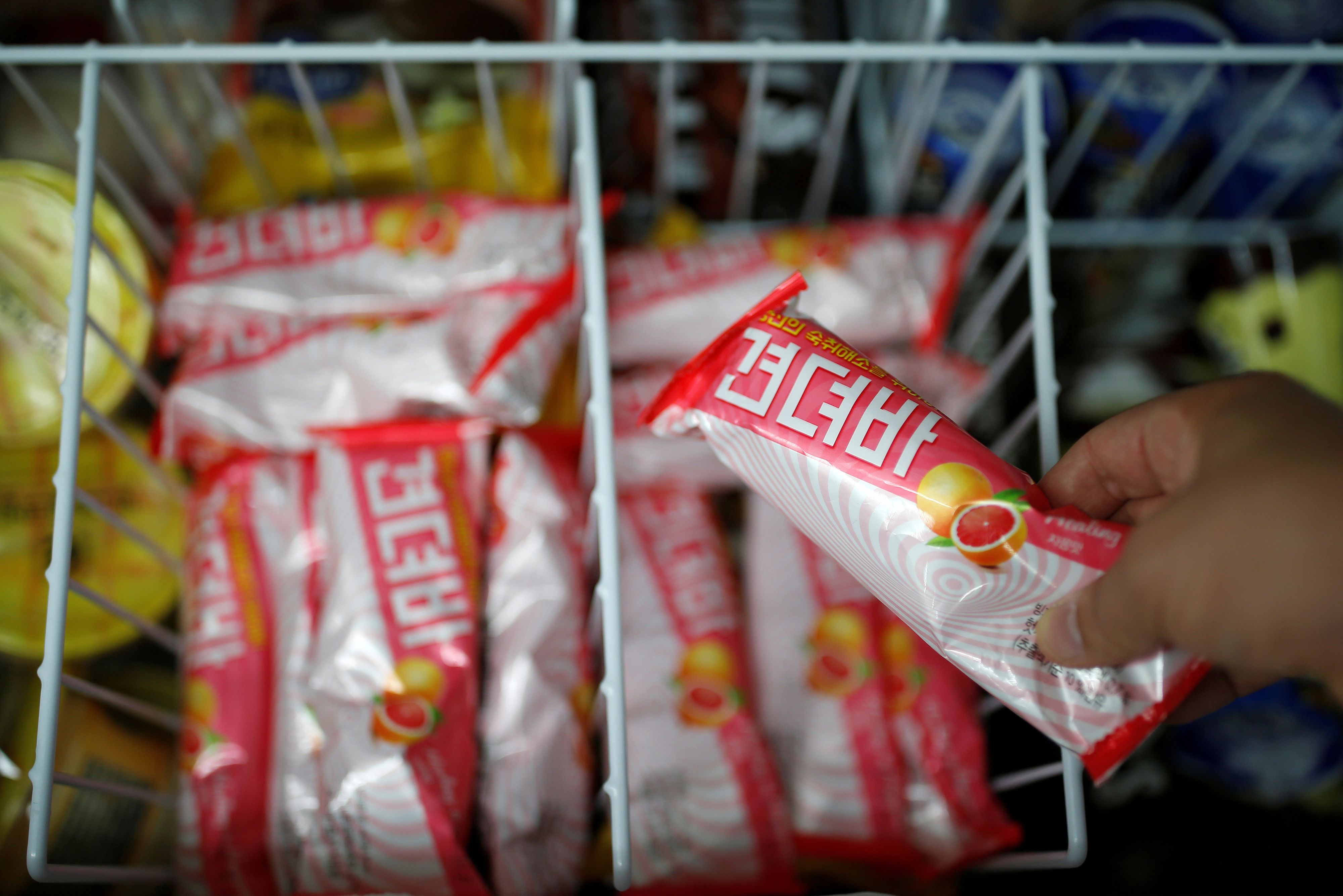 A clerk arranges ice cream bars named Gyeondyo-bar, which translates to 