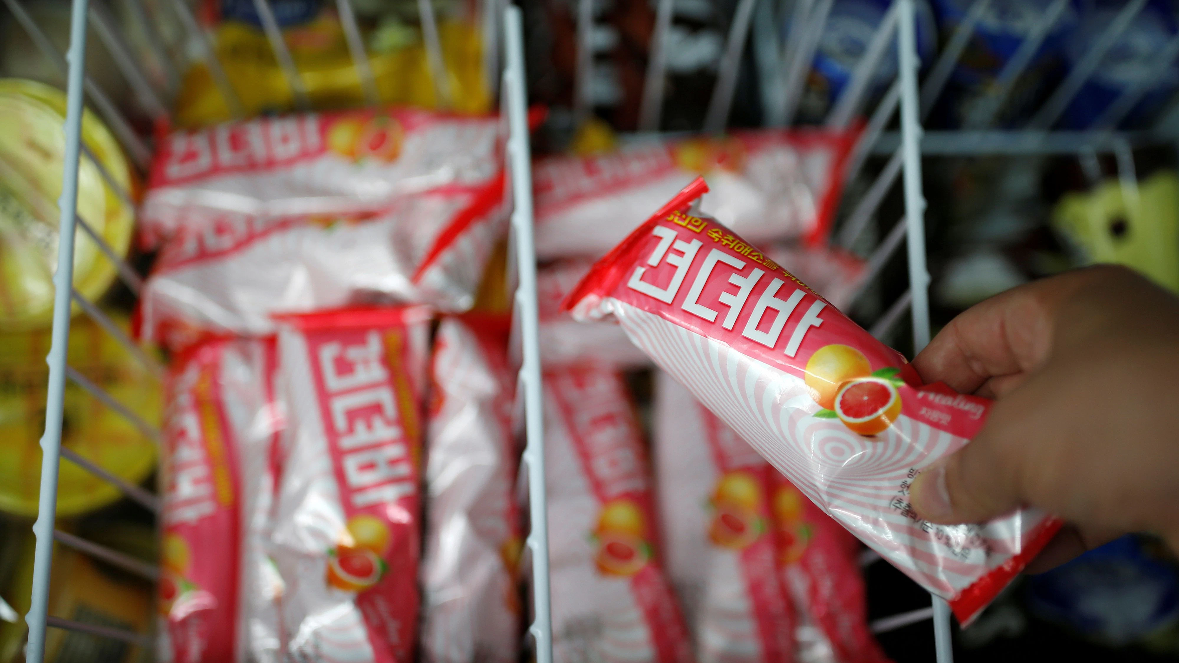 A clerk arranges ice cream bars named Gyeondyo-bar, which translates to "hang in there" at a convenience store in Seoul, South Korea, May 20, 2016. REUTERS/Kim Hong-Ji
