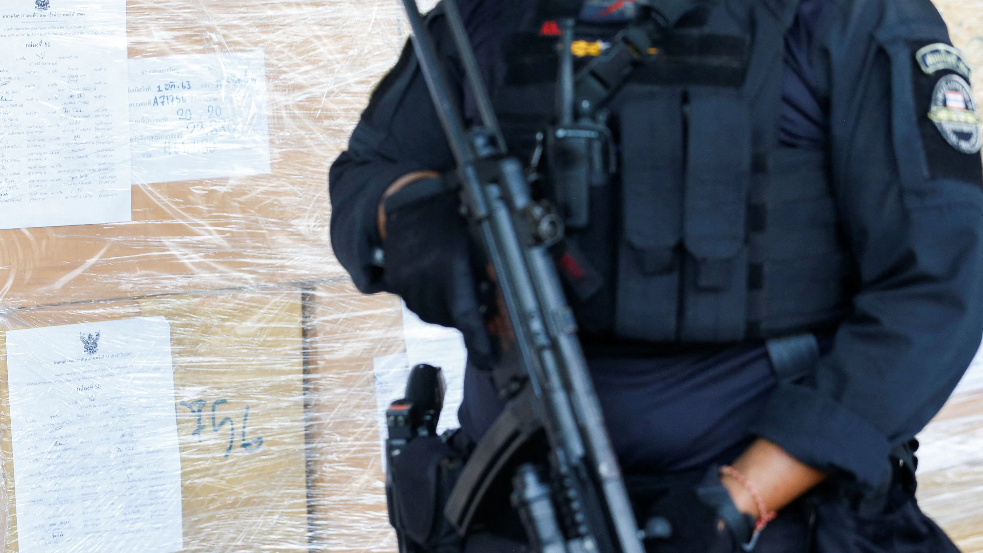 A police officer stands guard near confiscated drugs as Thai authorities are about to destroy them in Bangkok, Thailand July 5, 2022. REUTERS/Soe Zeya Tun