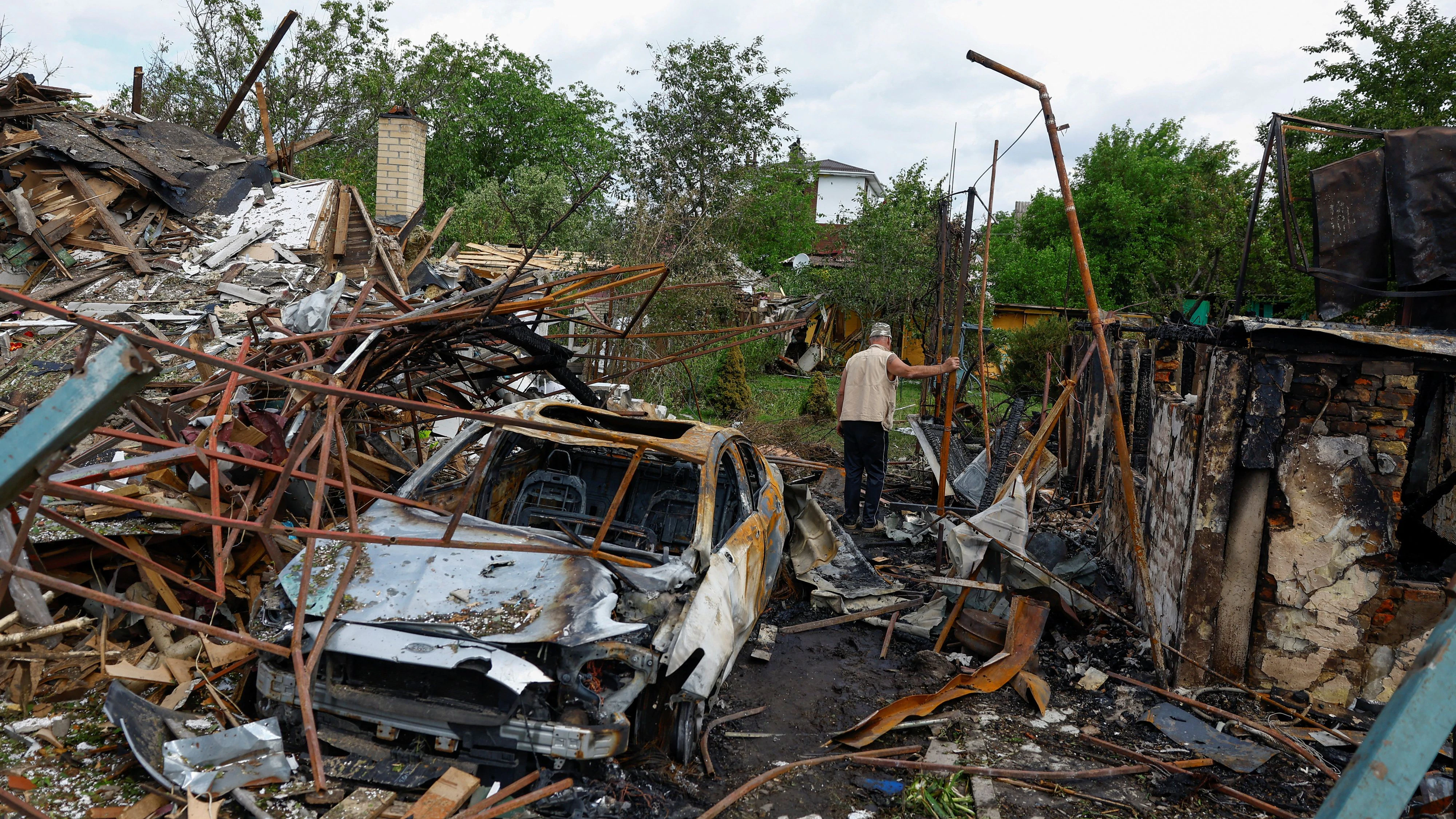 Resident Vasyl inspects a yard of his neighbours, which was damaged during Russian missile and drone strikes, amid Russia's attack on Ukraine, in Kyiv, Ukraine June 15, 2026. REUTERS/Valentyn Ogirenko