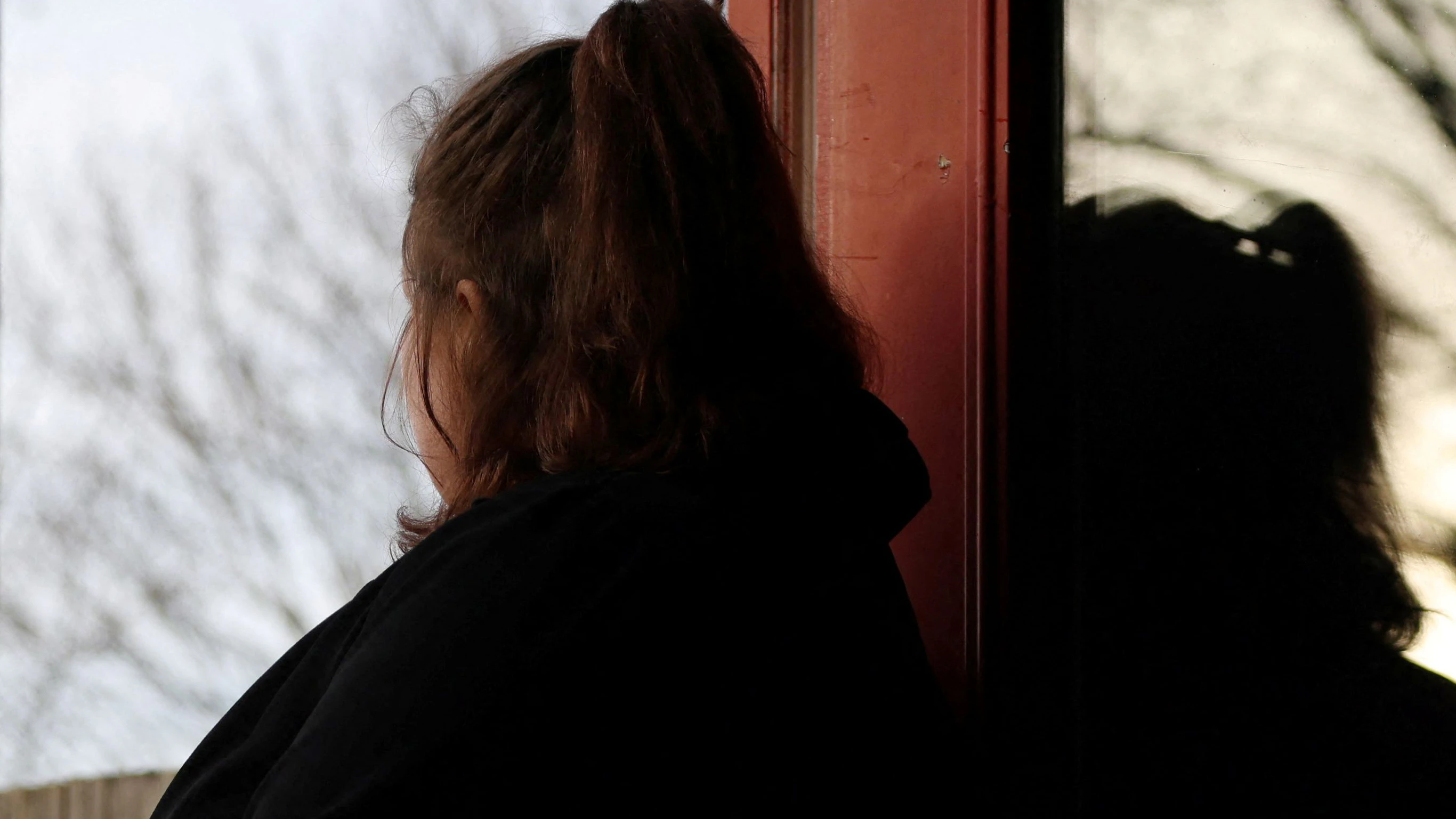 A woman poses at her home in England, Britain, January 8, 2025. She was 14 when she was sexually abused by a grooming gang in Rochdale. REUTERS/Hollie Adams