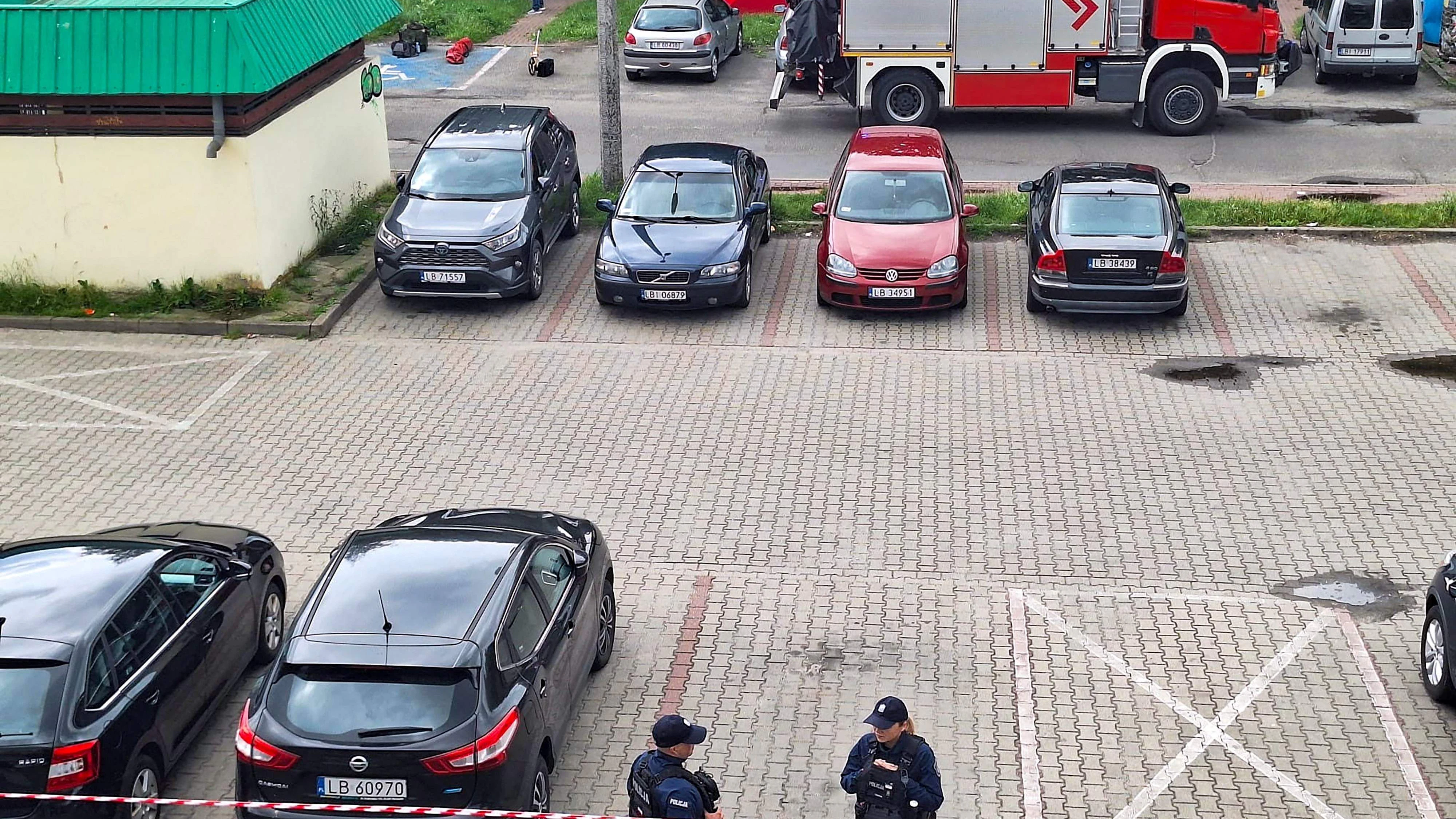 This general view taken on June 16, 2026 shows an area cordoned off by police around a crime scene covered with a tent (back C) near a car park in Biala Podlaska, eastern Poland, where Russian artist Semyon Skrepetsky, known for his satirising Russian President Putin has been shot dead. "An investigation is being conducted... into the murder of a 44-year-old citizen of the Russian Federation... known in the media as Semyon Skrepetsky," a spokesman for the prosecutor's office in Lublin, Marcin Kozak, told journalists. Two Belarusian nationals have been arrested in connection with the killing, he added. They were detained in the vicinity of the Belarusian consulate in Biala Podlaska in eastern Poland, where the killing took place. (Photo by Piotr PYRKOSZ / Slowo Podlasia / AFP)