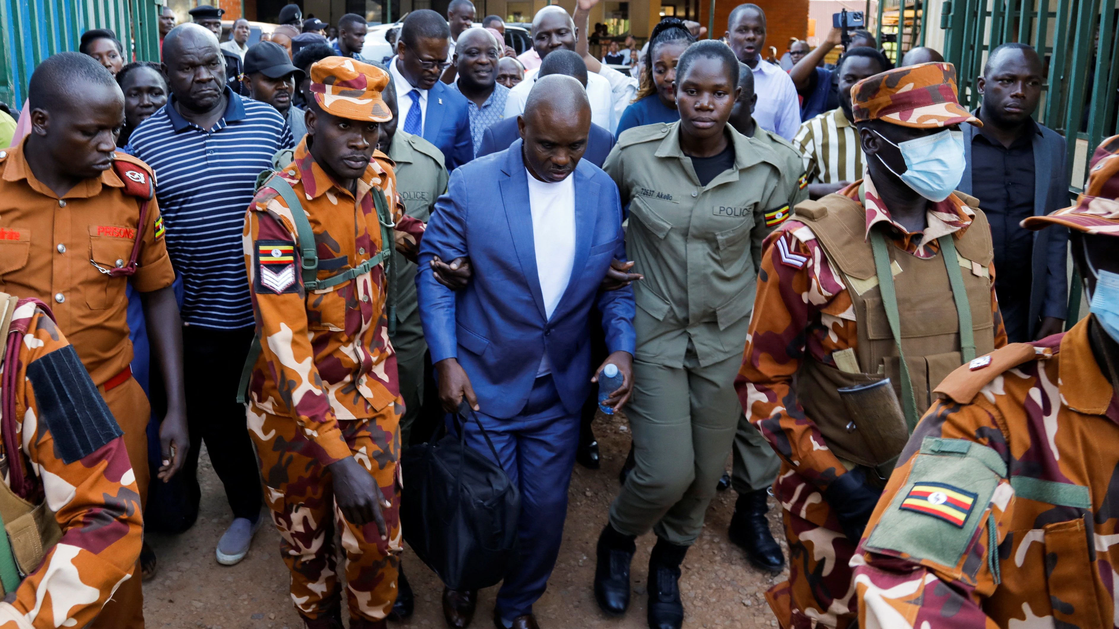 Lawyer Erias Lukwago, who represents detained People's Front for Freedom party leader Kizza Besigye, is escorted by police and prison officers after being remanded to Luzira Prison on charges of misprision of treason, in Kampala, Uganda, June 17, 2026. REUTERS/Abubaker Lubowa