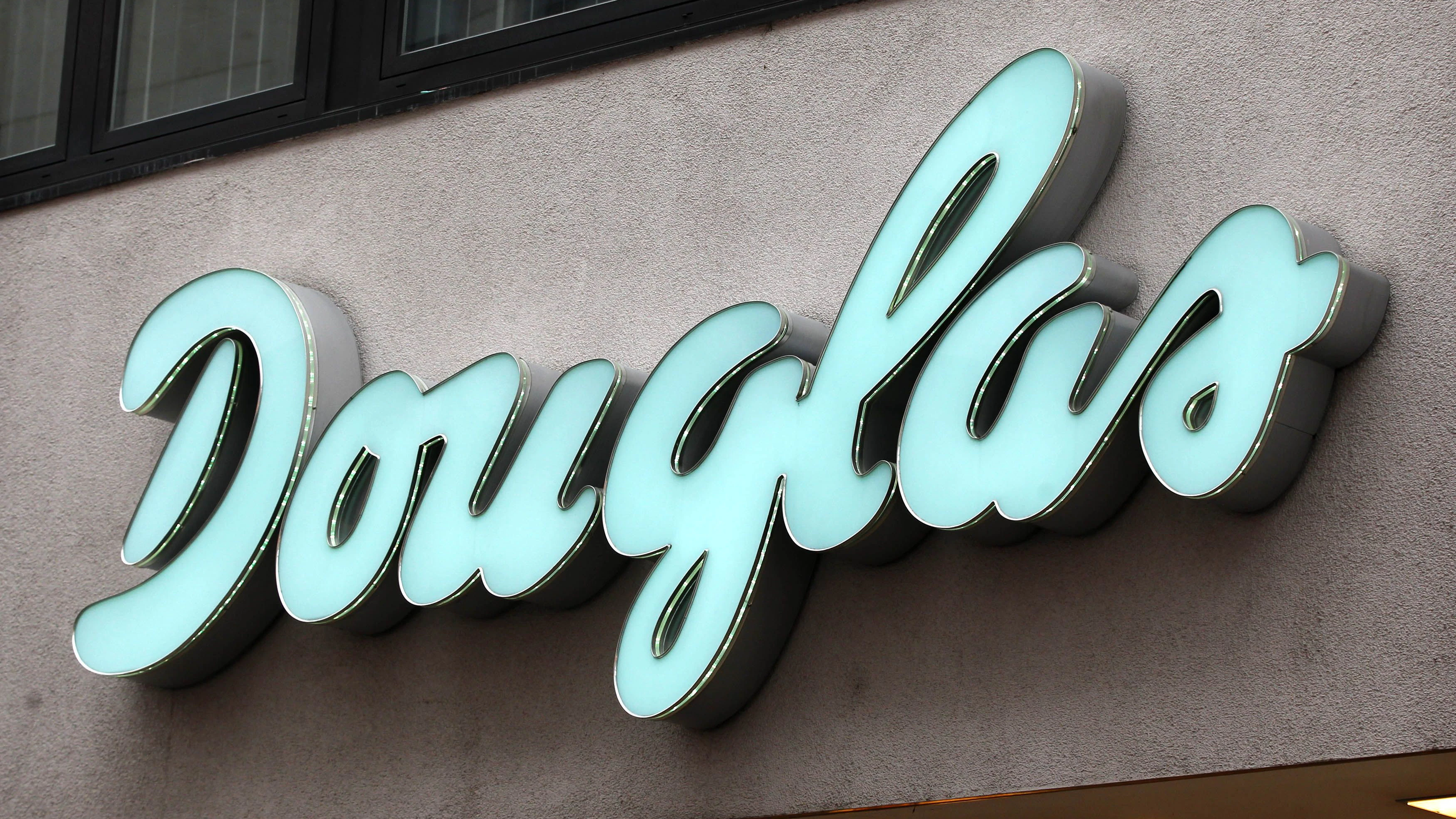 A logo of perfumes retailer Douglas Holding AG is pictured at a branch of perfumery chain Douglas in Cologne January 21, 2013. REUTERS/Ina Fassbender (GERMANY - Tags: BUSINESS)