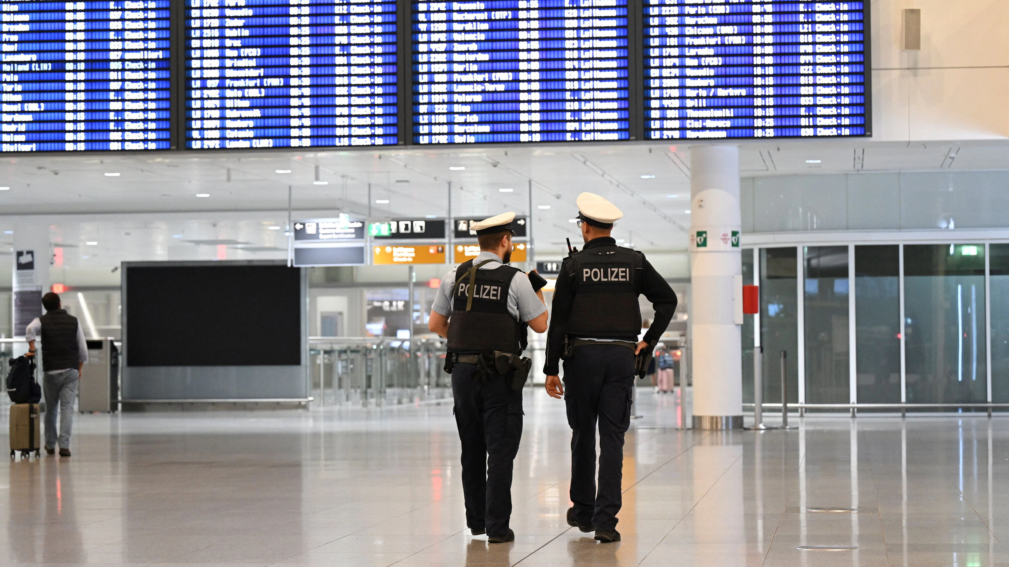 Police officers walk at the airport in Munich, after both runways at Munich airport were closed on Friday evening for the second time in less than 24 hours after drones were again sighted, authorities said, in Germany, October 3, 2025. REUTERS/Angelika Warmuth