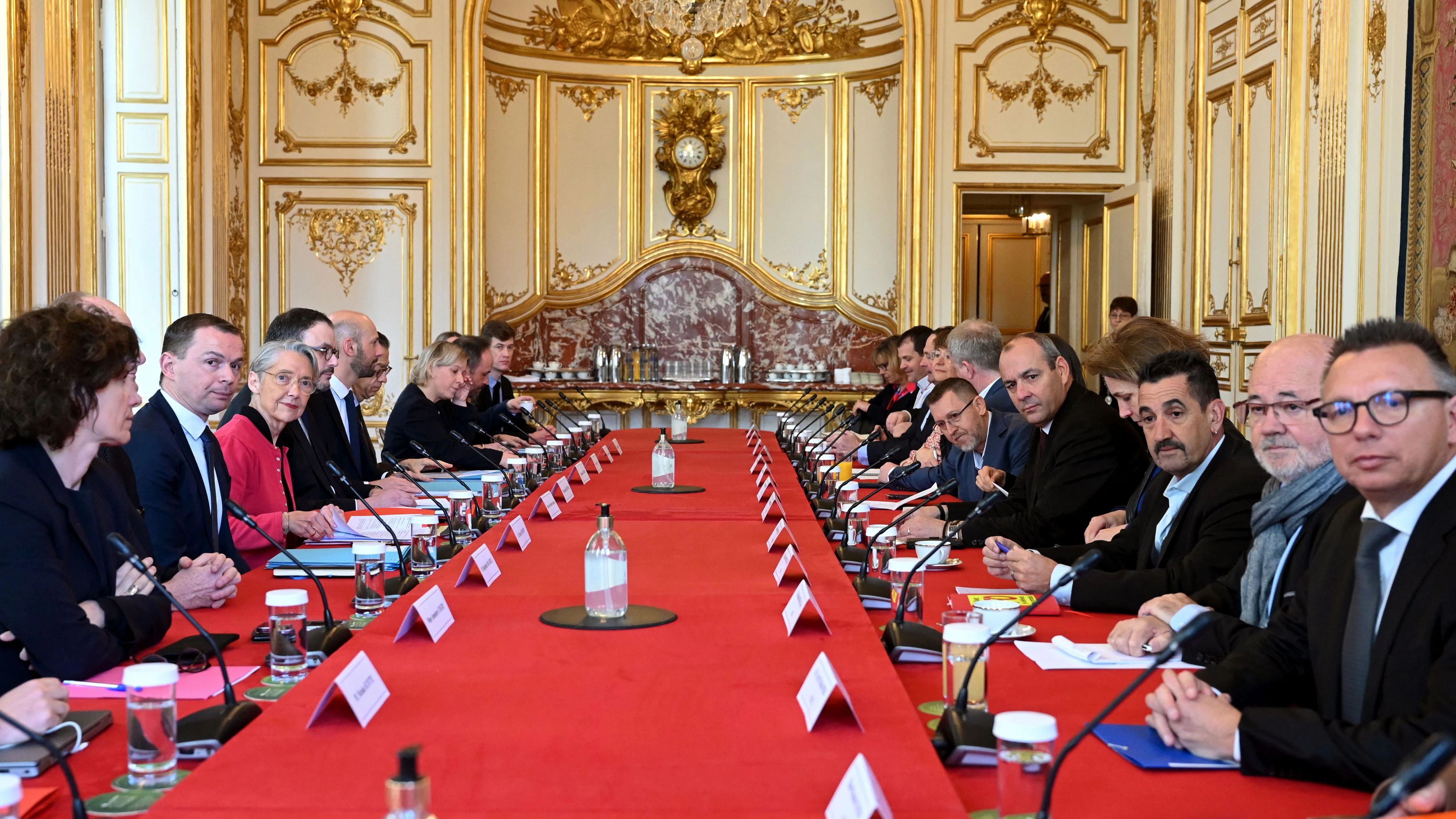 French Prime Minister Elisabeth Borne and inter-unions representatives pose prior to talks at Hotel de Matignon in Paris, France April 5, 2023 after a pensions reform was pushed through parliament by the French government without a vote, using the article 49.3 of the constitution. Bertrand Guay/Pool via REUTERS