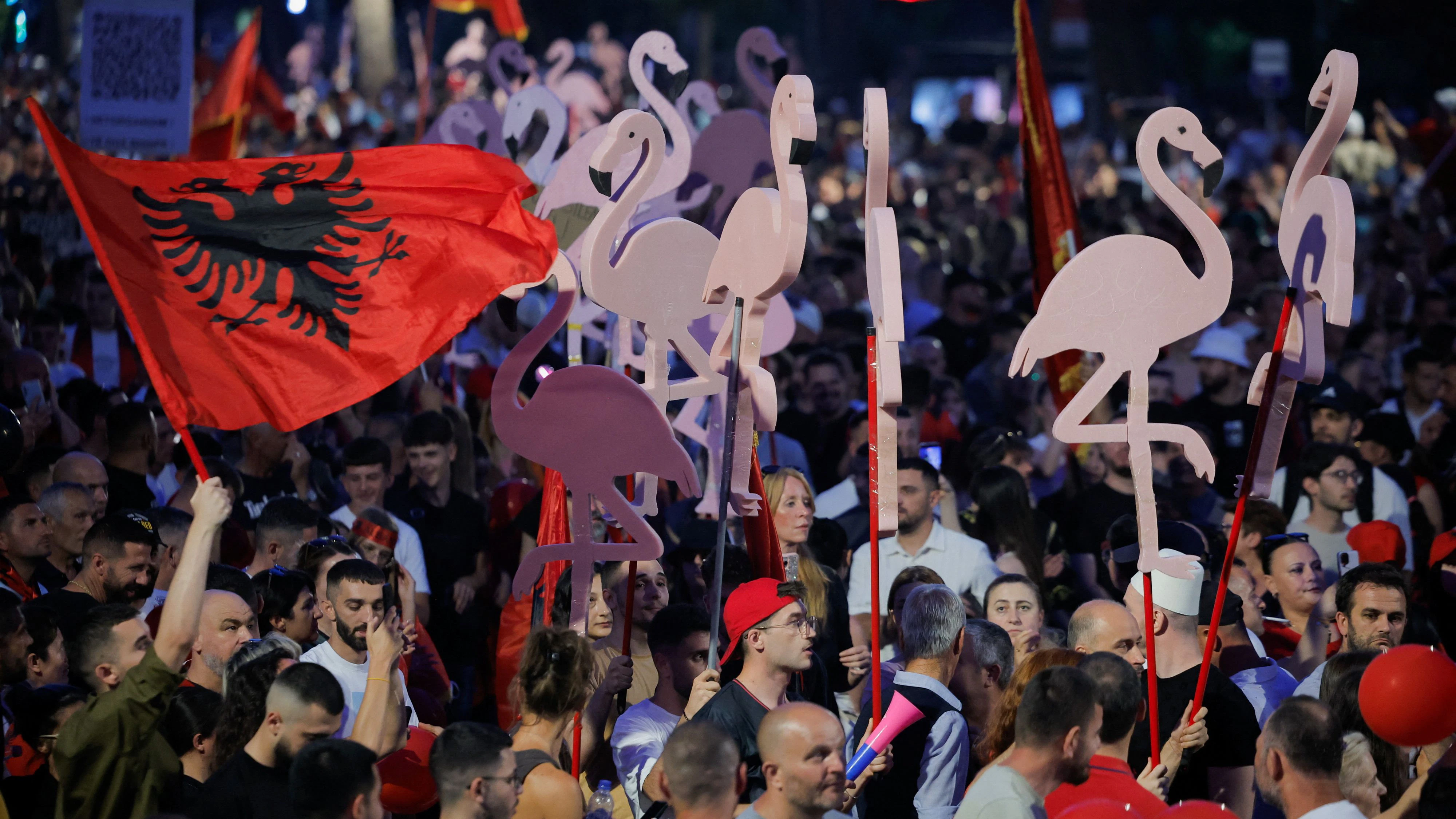 Protesters hold flamingo-shaped placards as they demonstrate against the government, following weeks of protests against a planned luxury resort backed by a company linked to Jared Kushner, the son-in-law of U.S. President Donald Trump, on an environmentally sensitive part of the Adriatic coast, in Tirana, Albania, June 21, 2026. REUTERS/Valdrin Xhemaj