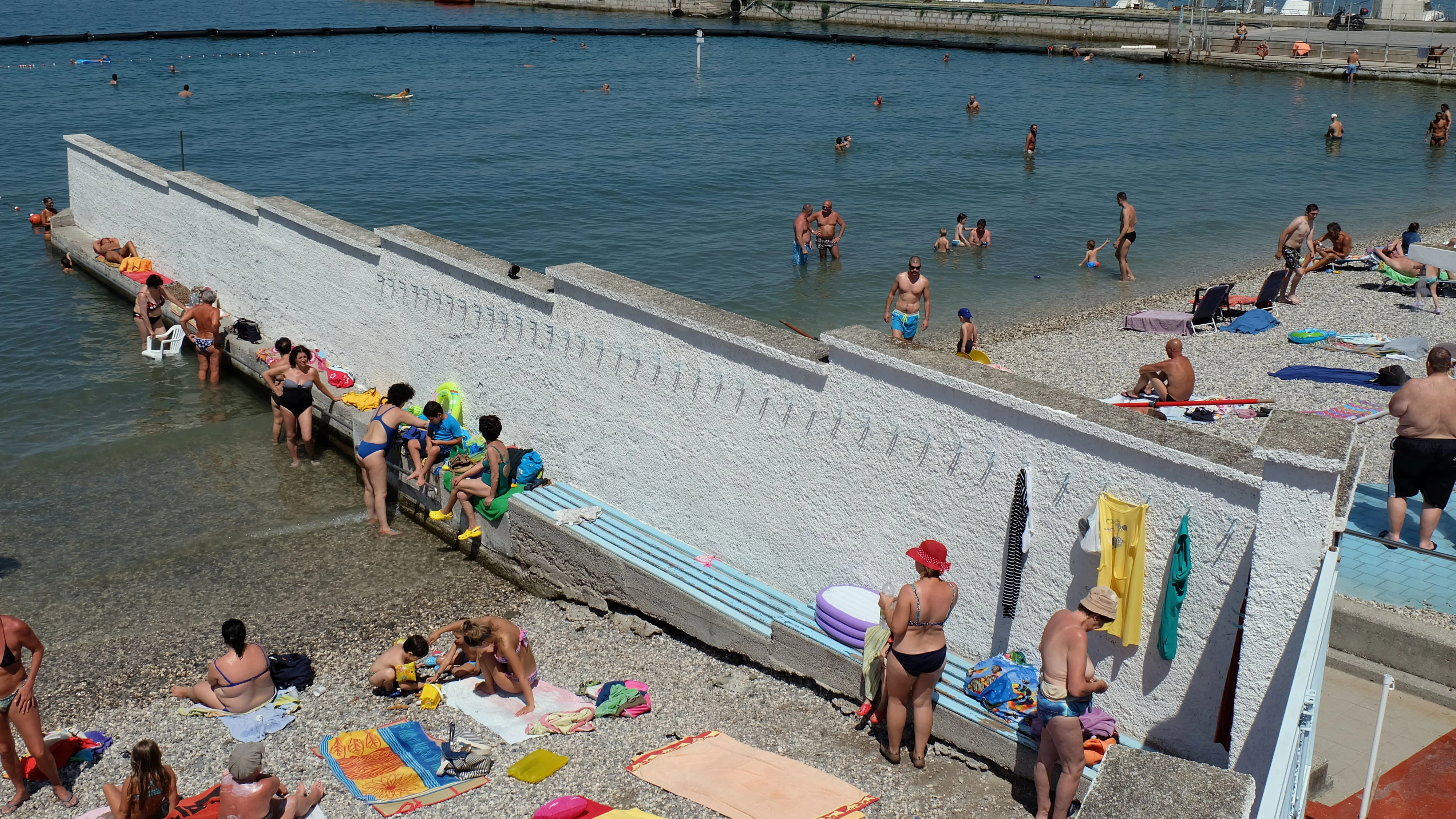 Vacationers can be seen in both the male and female parts of the public bath "Laterne", known as "El Pedocin" in Triest, Italy, 9 July 2017. The beach has upheld a strict seperation according to genders for 114 years now - it is the last of its kind in Europe. The vacationers, however, are satisfied with the system. Photo: Alvise Armellini/dpa