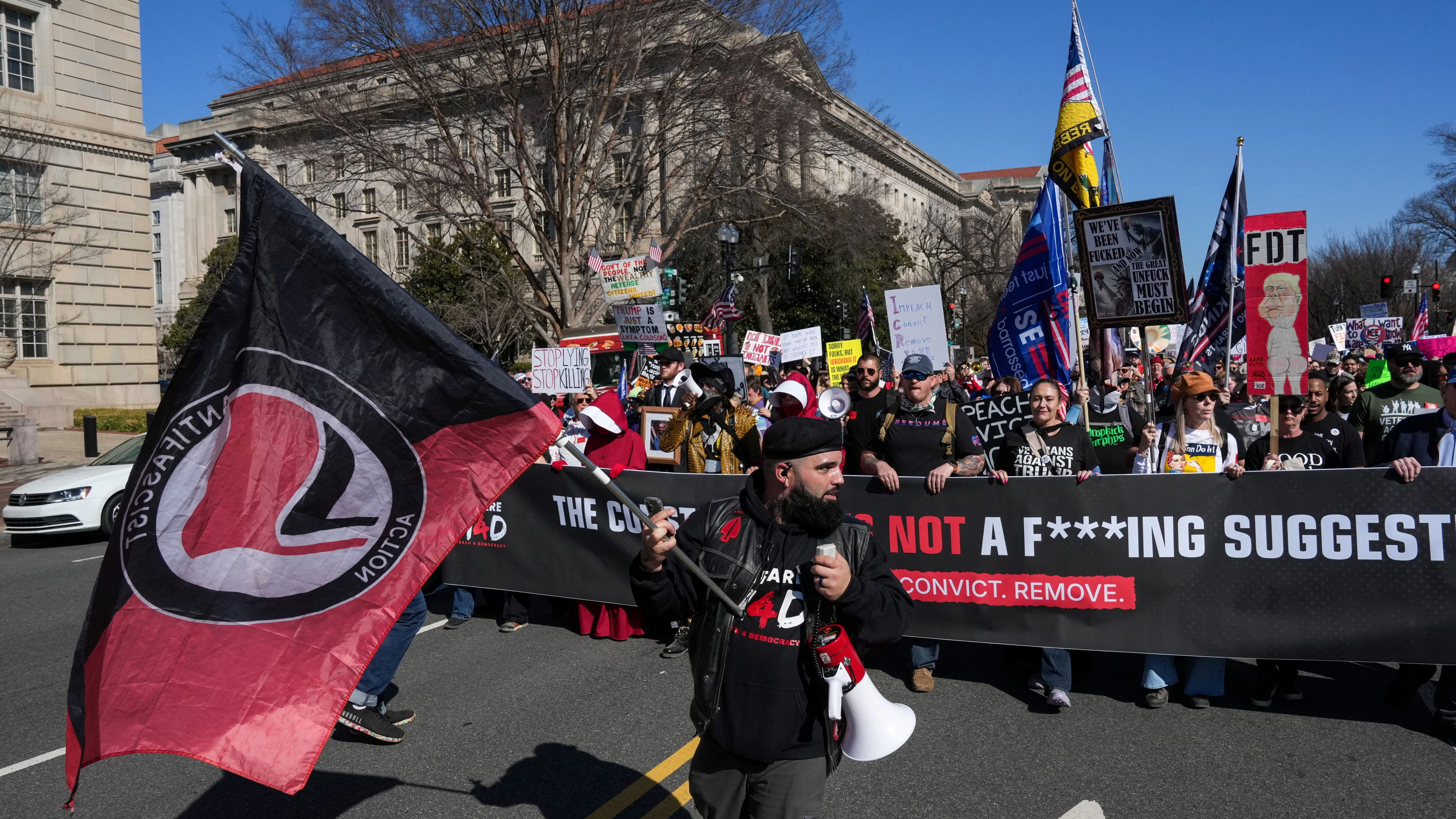  SENSITIVE MATERIAL. THIS IMAGE MAY OFFEND OR DISTURB    Event organizer Thomas Sidle holds an Antifa flag as demonstrators behind him hold a banner, during the March4Democracy march, in Washington D.C., U.S., February 28, 2026. REUTERS/Leah Millis 