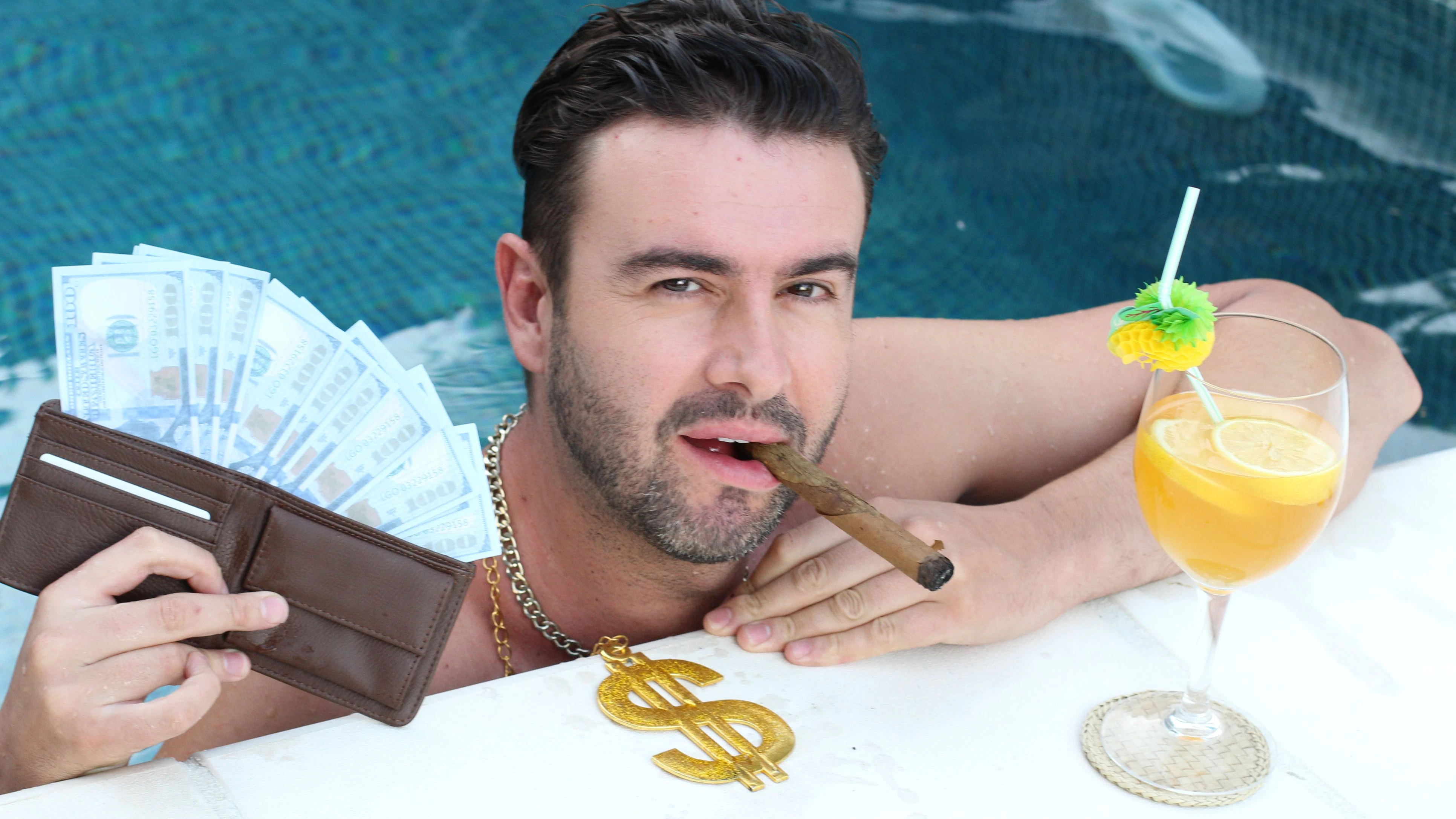 Arrogant man in swimming pool with money, cocktail and cigar.