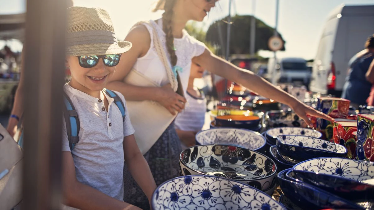 Kids tourists buying sourvenirs on local flea market in Andalusia, Spain.  