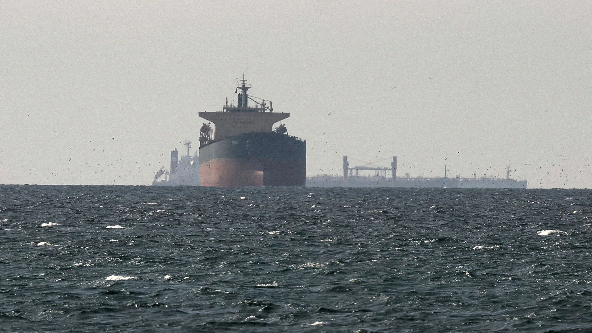 FILE PHOTO: FILE PHOTO: Cargo ships in the Gulf, near the Strait of Hormuz, as seen from northern Ras al-Khaimah, near the border with Oman’s Musandam governance, amid the U.S.-Israeli conflict with Iran, in United Arab Emirates, March 11, 2026. REUTERS/Stringer/File Photo