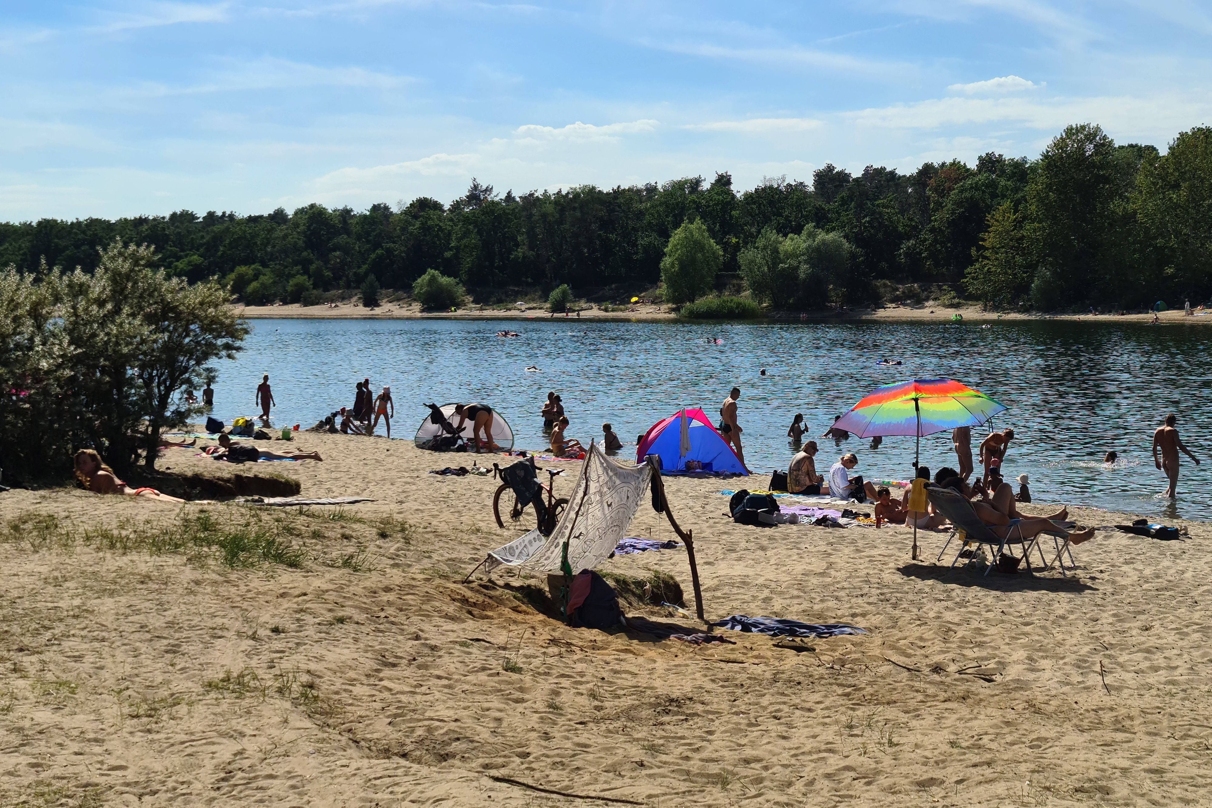 Menschen am Kaulsdorfer Baggersee an einem heißen Sommertag in Berlin.