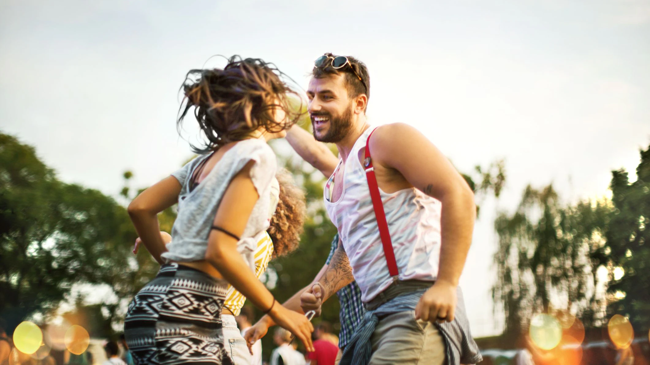Young couple dancing at music festival.