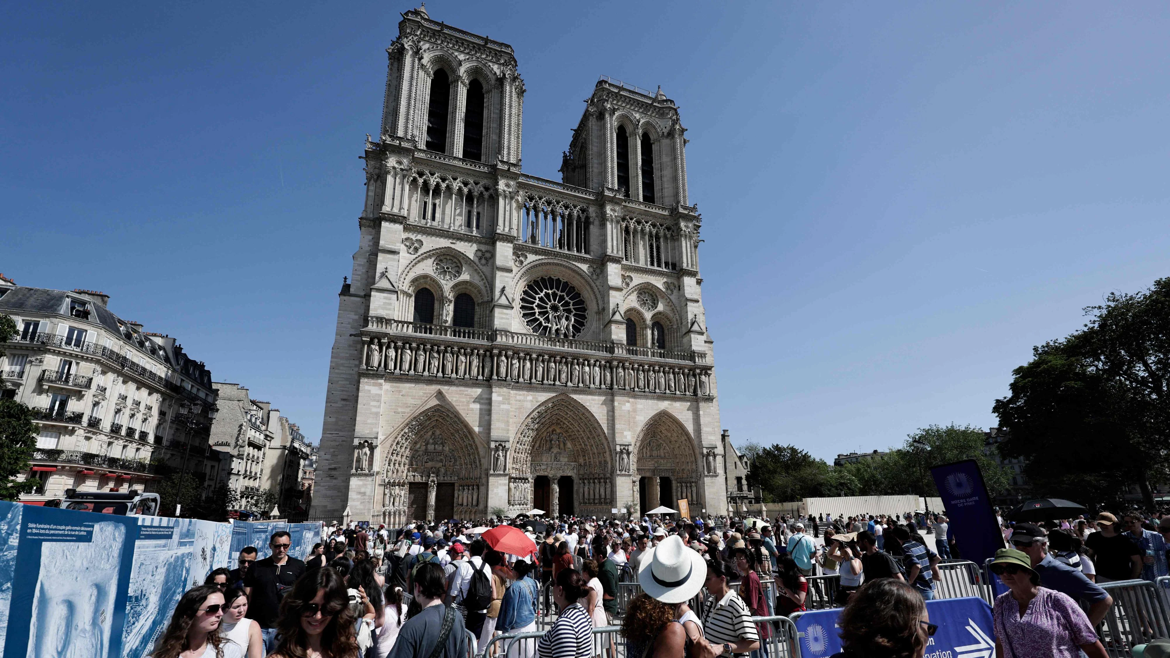 Visitors queue to enter the Notre-Dame Cathedral in central Paris on May 23, 2026. (Photo by STEPHANE DE SAKUTIN / AFP)