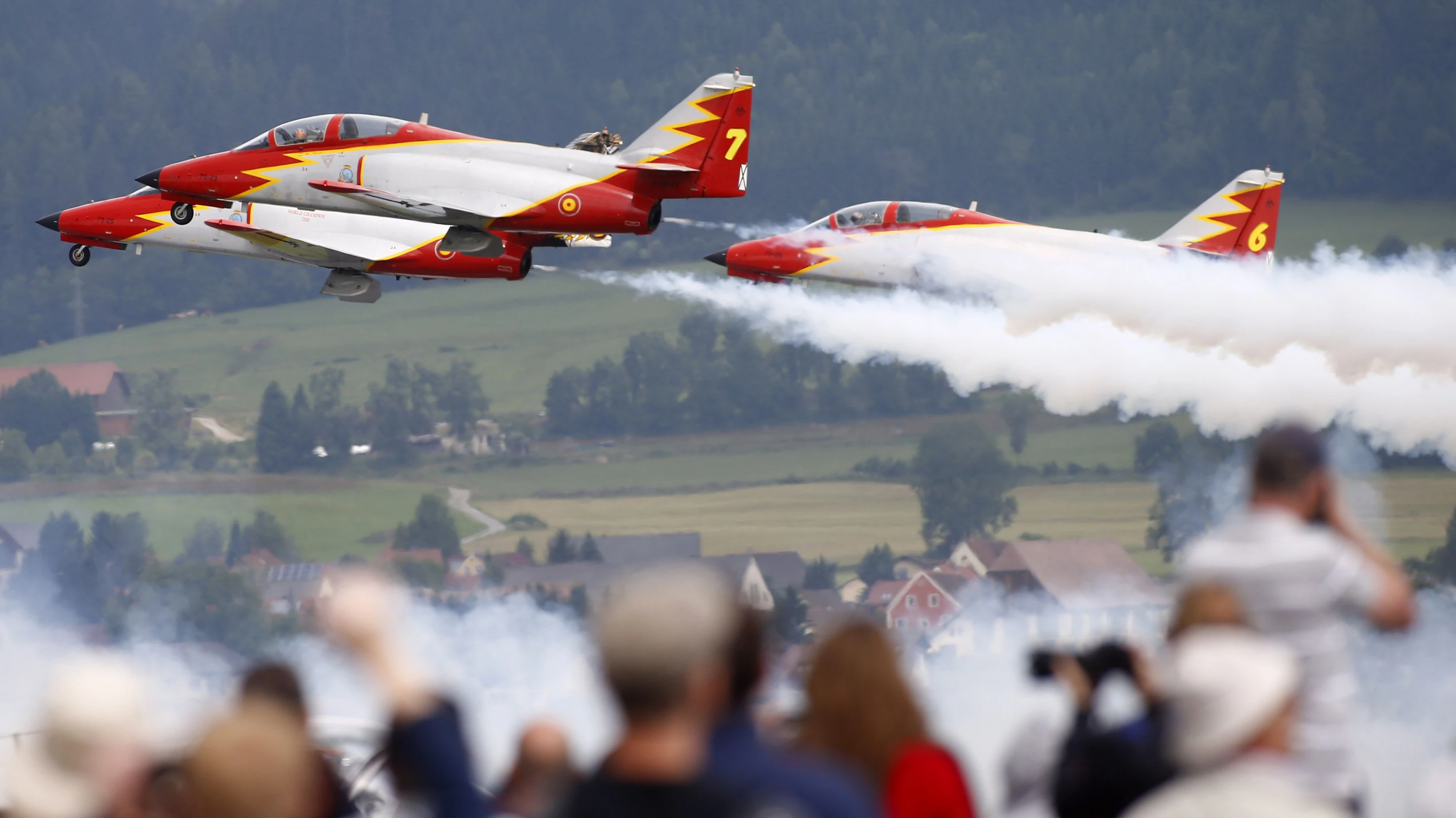 Members of the Spanish aerobatic team Patrulla Aguila perform during the AirPower 13 air show at the Hinterstoisser air base in Zeltweg June 28, 2013. Over 200,000 spectators are expected to attend the air show which takes place June 28 to 29.  REUTERS/Dominic Ebenbichler   (AUSTRIA - Tags: ENTERTAINMENT TRANSPORT)