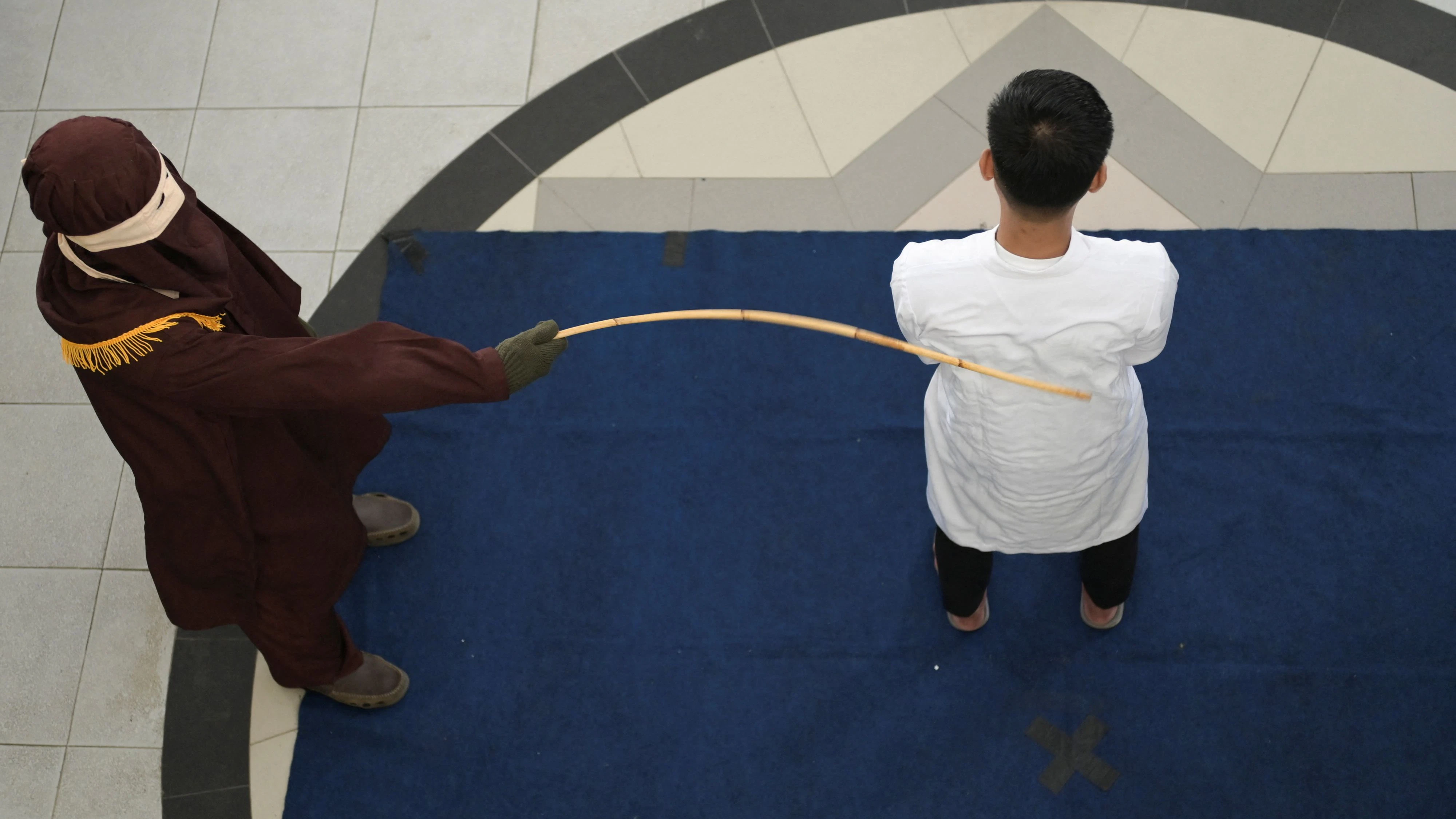 A man convicted of having same sex relationship is publicly caned by a Sharia Law official in Banda Aceh, Indonesia, February 27, 2025. REUTERS/Riska Munawarah