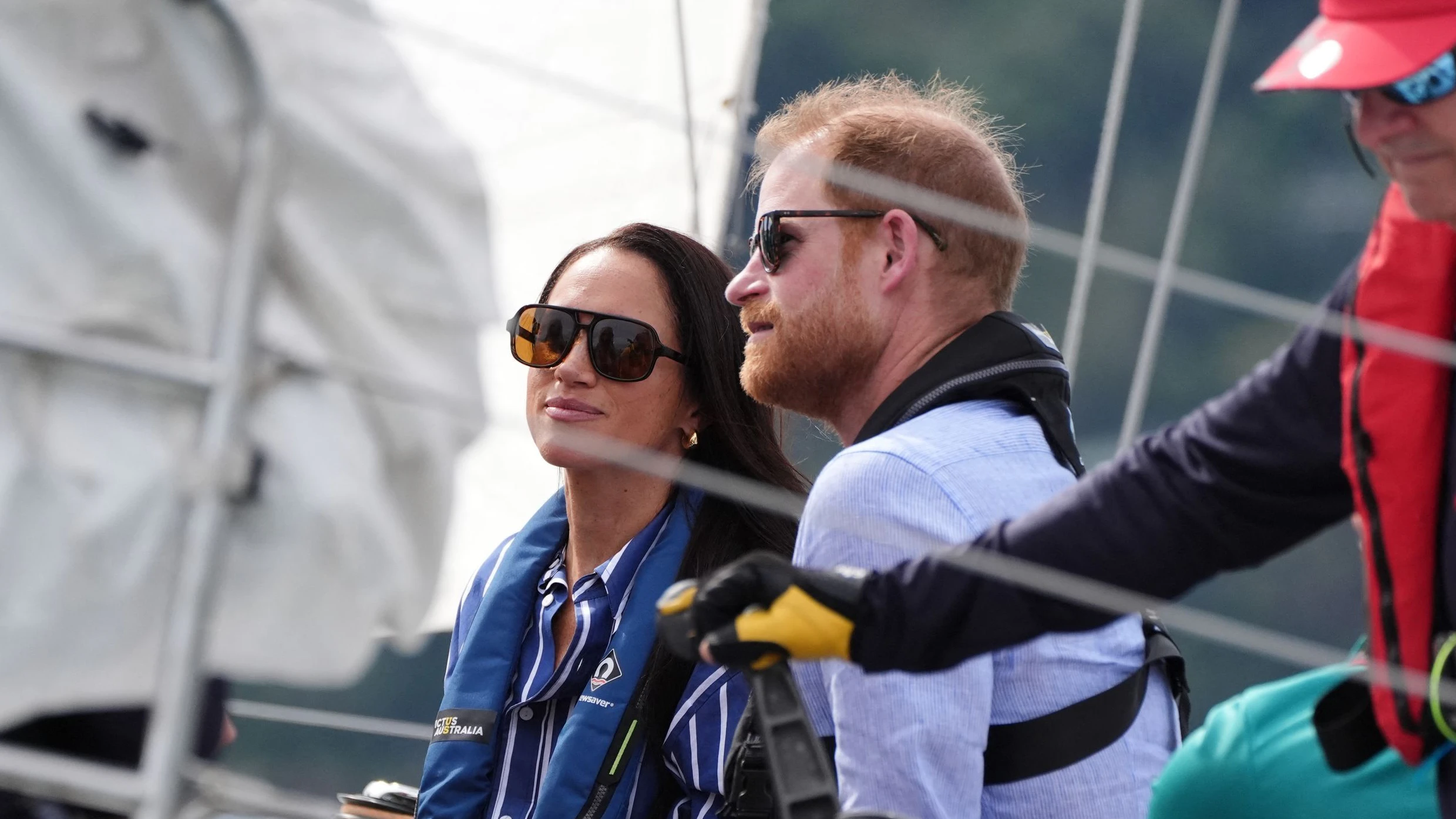 Britain's Prince Harry, Duke of Sussex, and his wife Meghan, the Duchess of Sussex, take part in a sailing event with members of Invictus Australia in Sydney Harbour on April 17, 2026. (Photo by Jonathan Brady / POOL / AFP)