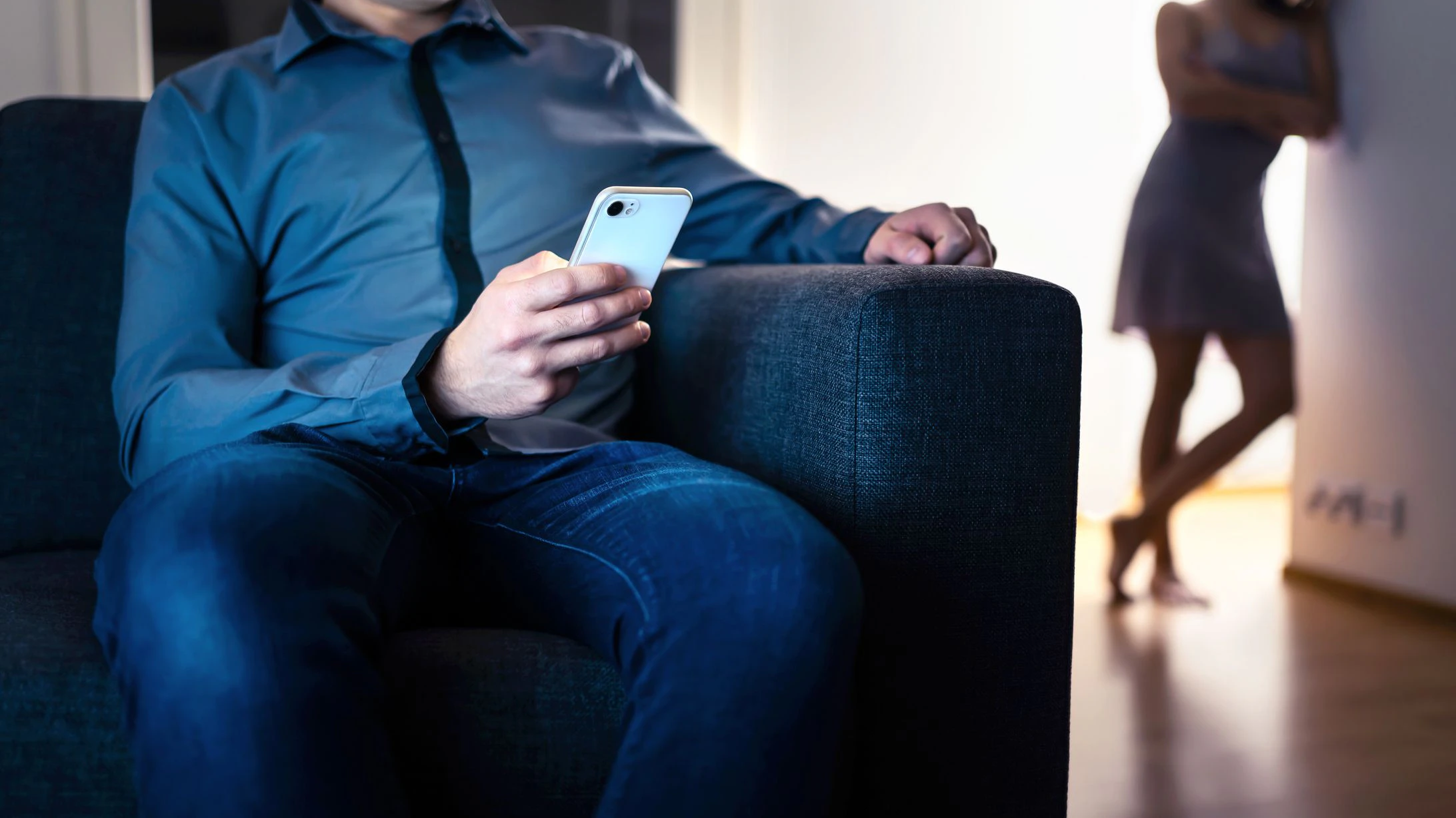 Jealous woman and cheating man with a phone. Infidelity, jealousy and betrayal. Cheater husband texting with mistress and secret lover. Suspicious wife peeking and spying. Unfaithful sneaky boyfriend.