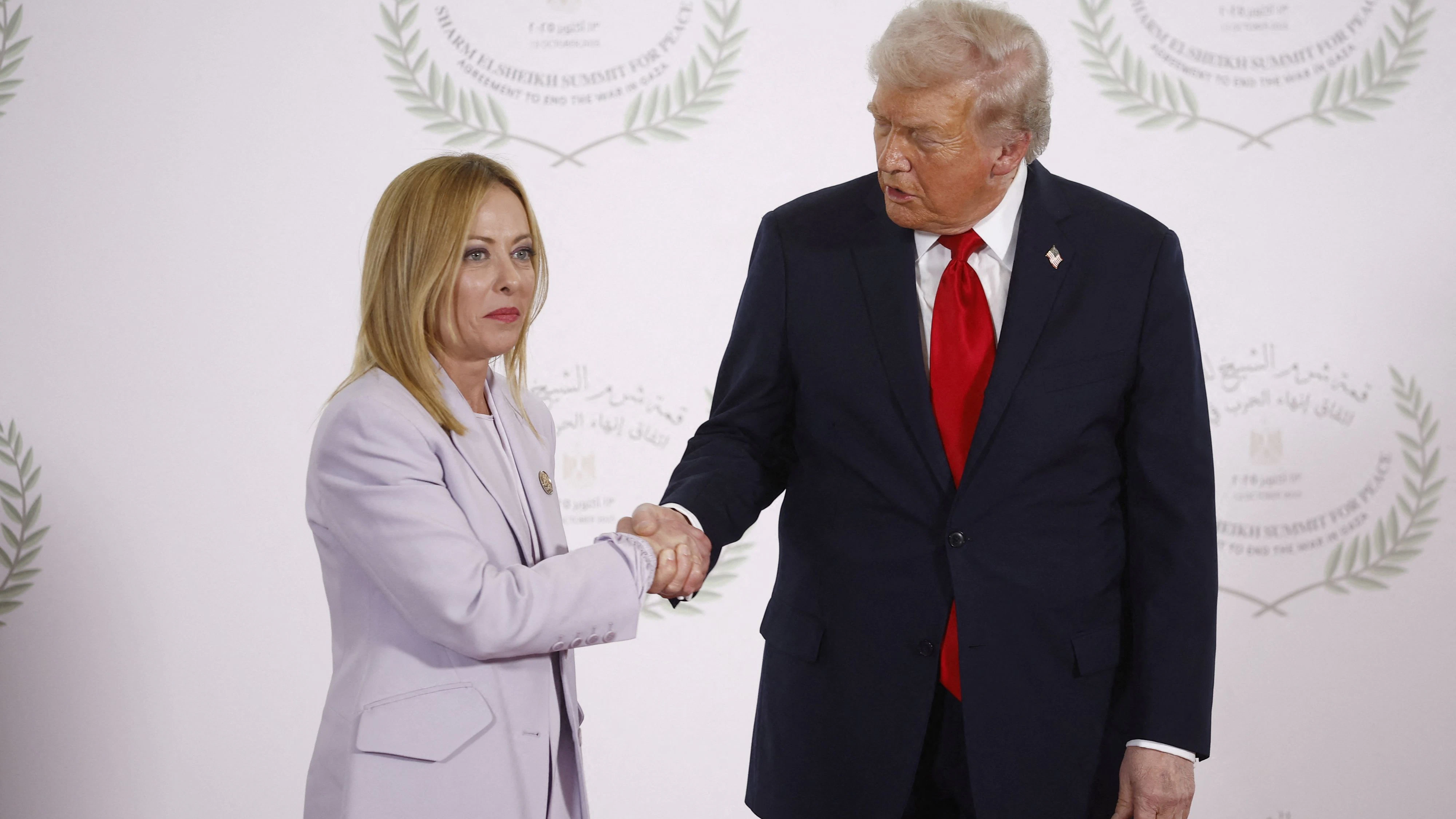 U.S. President Donald Trump and Italian Prime Minister Giorgia Meloni shake hands as they pose for a photo, at a world leaders' summit on ending the Gaza war, amid a U.S.-brokered prisoner-hostage swap and ceasefire deal between Israel and Hamas, in Sharm el-Sheikh, Egypt, October 13, 2025. Yoan Valat/Pool via REUTERS
