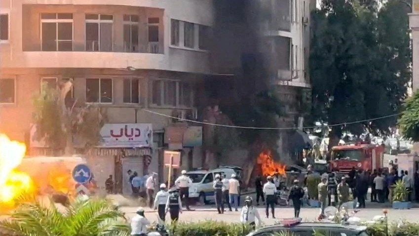Emergency personnel work as smoke and fire rise at the site where explosive devices blew up near a hotel where French President Emmanuel Macron was meant to be staying, in Damascus, Syria, in this screengrab obtained from a video, July 7, 2026. REUTERS/Yamam Al Shaar        TPX IMAGES OF THE DAY     