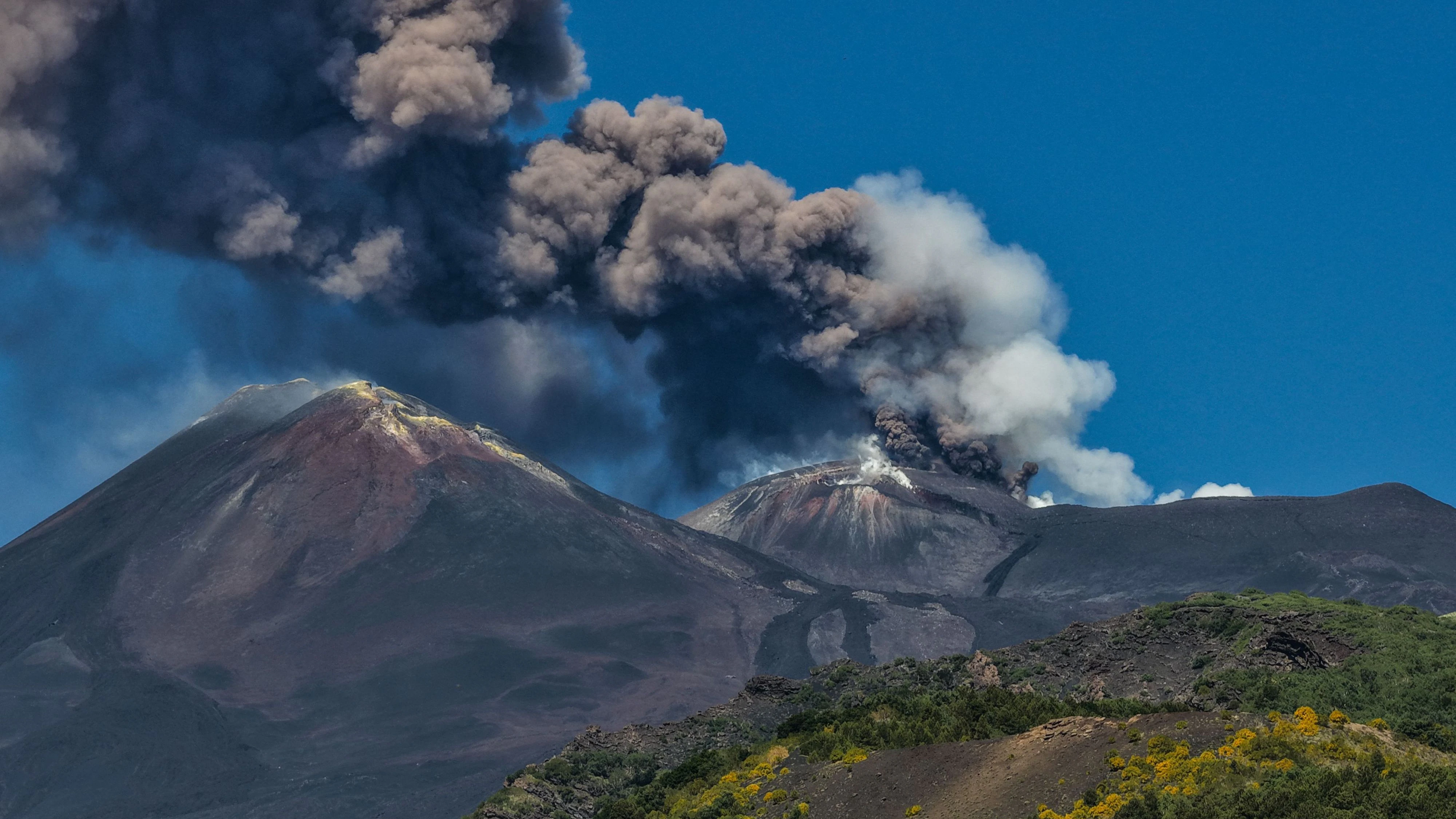 A photograph taken on July 5, 2026 shows smoke rising from the crater during an eruption of the Mount Etna volcano in Sicily. (Photo by Etna Walk / AFP)