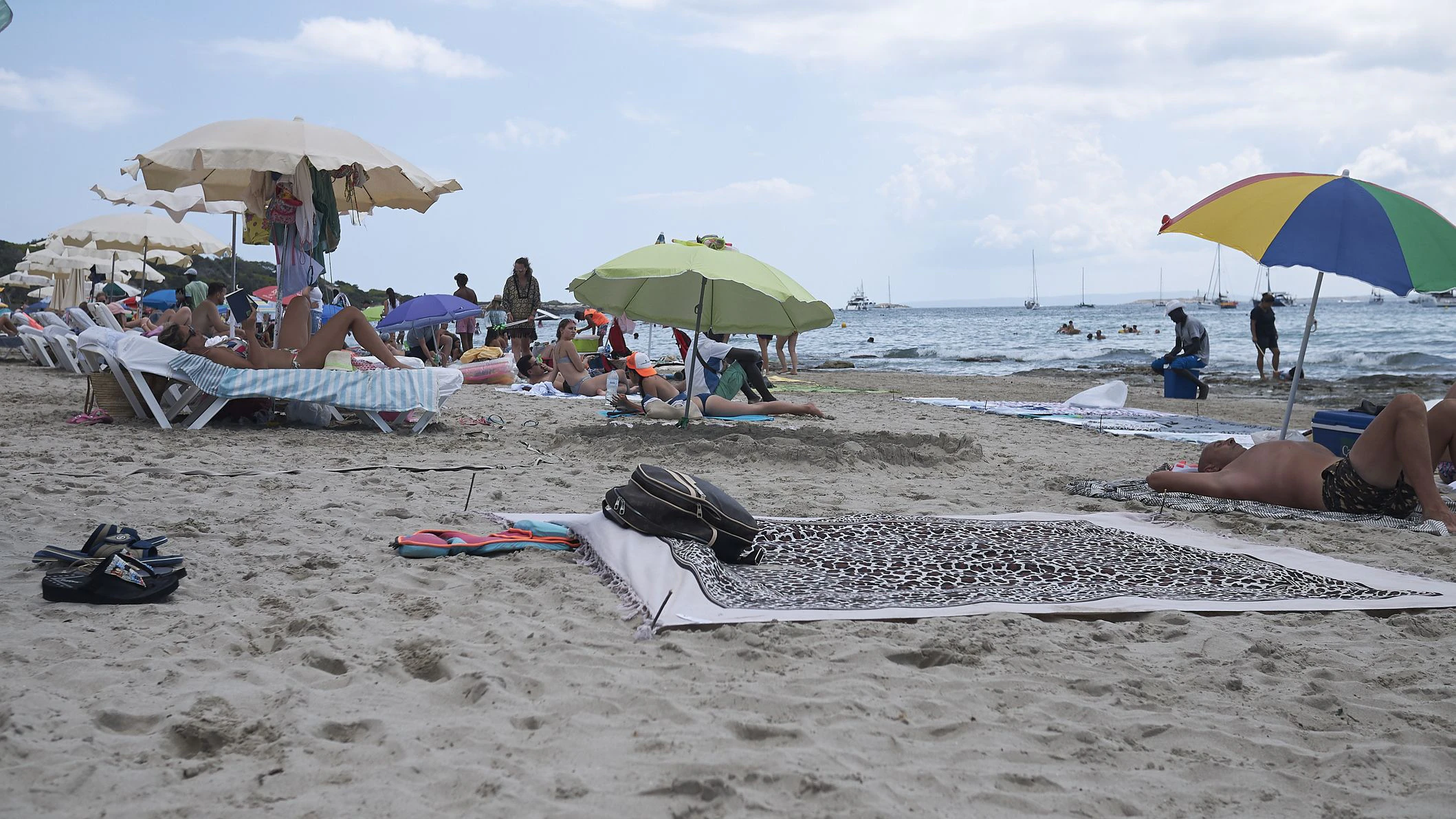 Ibiza, Spain - August 28, 2019  : Tourists tanning at Ses Salines beach