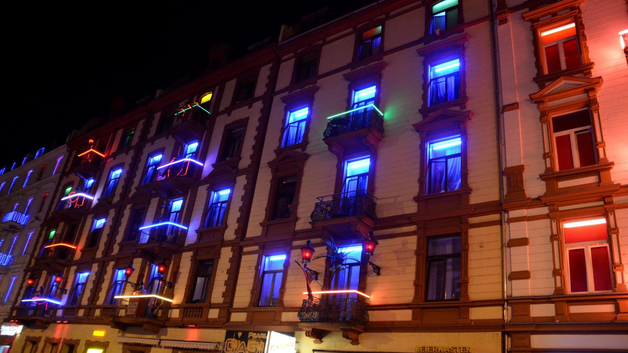 Frankfurt, Germany - July 28, 2016: Frankfurt red light district in Bahnhofsviertel. Neon lighten Brothel facade in Elbestrasse, an alley with many eros centers, strip clubs and bars, a few hundred meters away from Frankfurt railway station. 