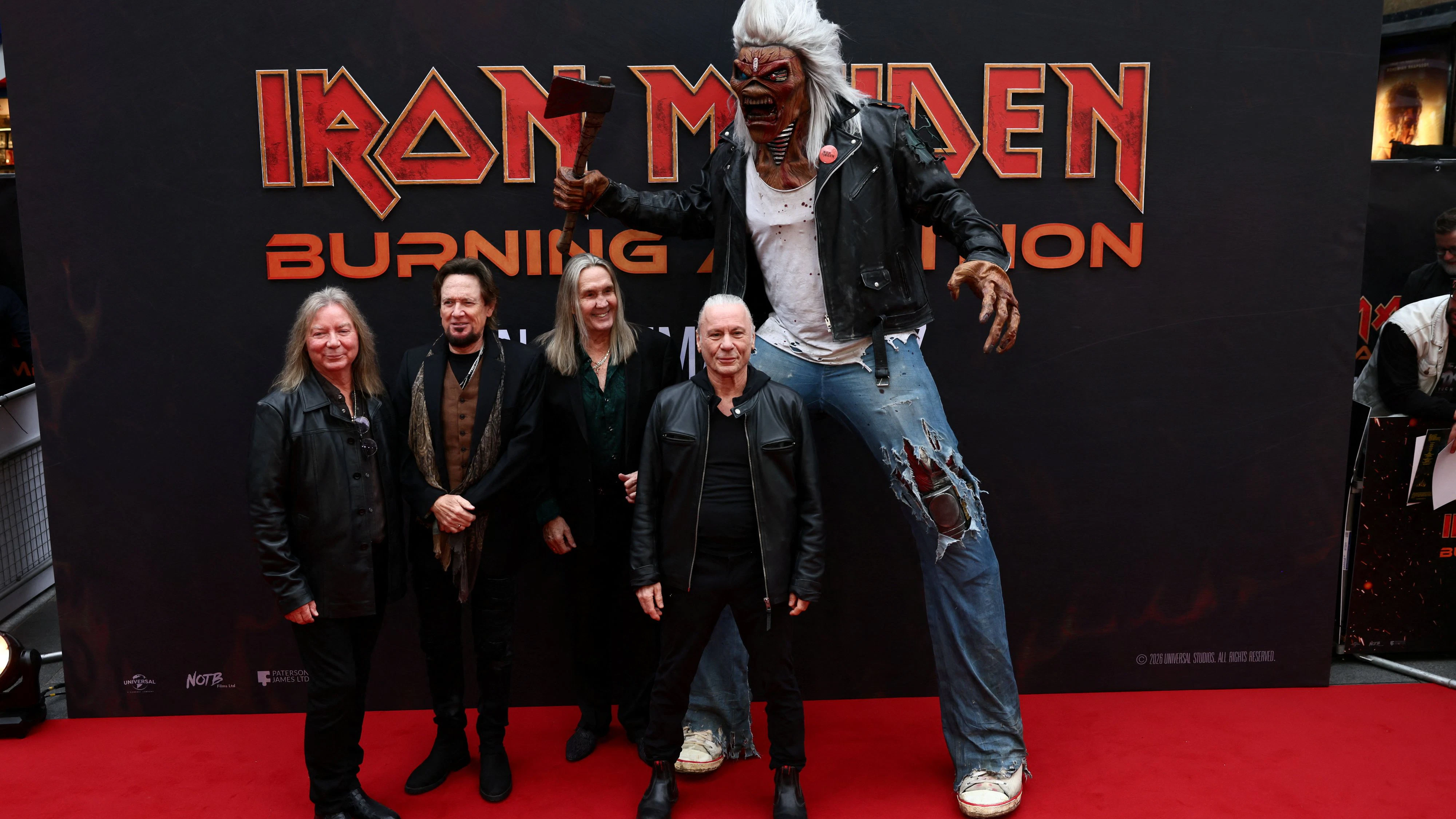 Dave Murray, Adrian Smith, Nicko McBrain and Bruce Dickinson of Iron Maiden, and the band mascot Eddie, attend the world premiere of the documentary film 'Iron Maiden: Burning Ambition' in London, Britain, May 5, 2026. REUTERS/Jack Taylor