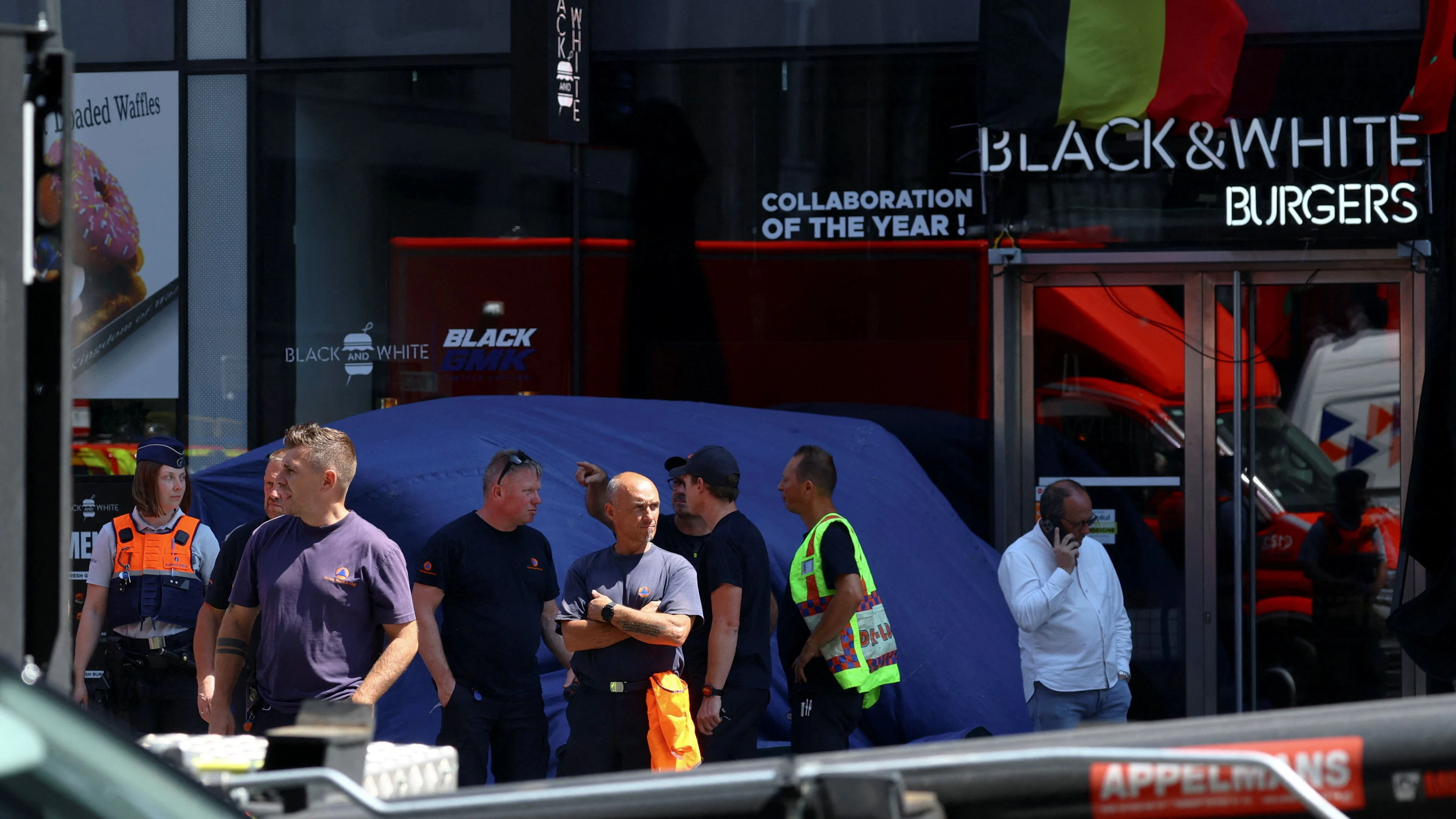 Emergency personnel gather, following a fire at Oxy Brussels building in Brussels, Belgium, July 14, 2026. REUTERS/Yves Herman