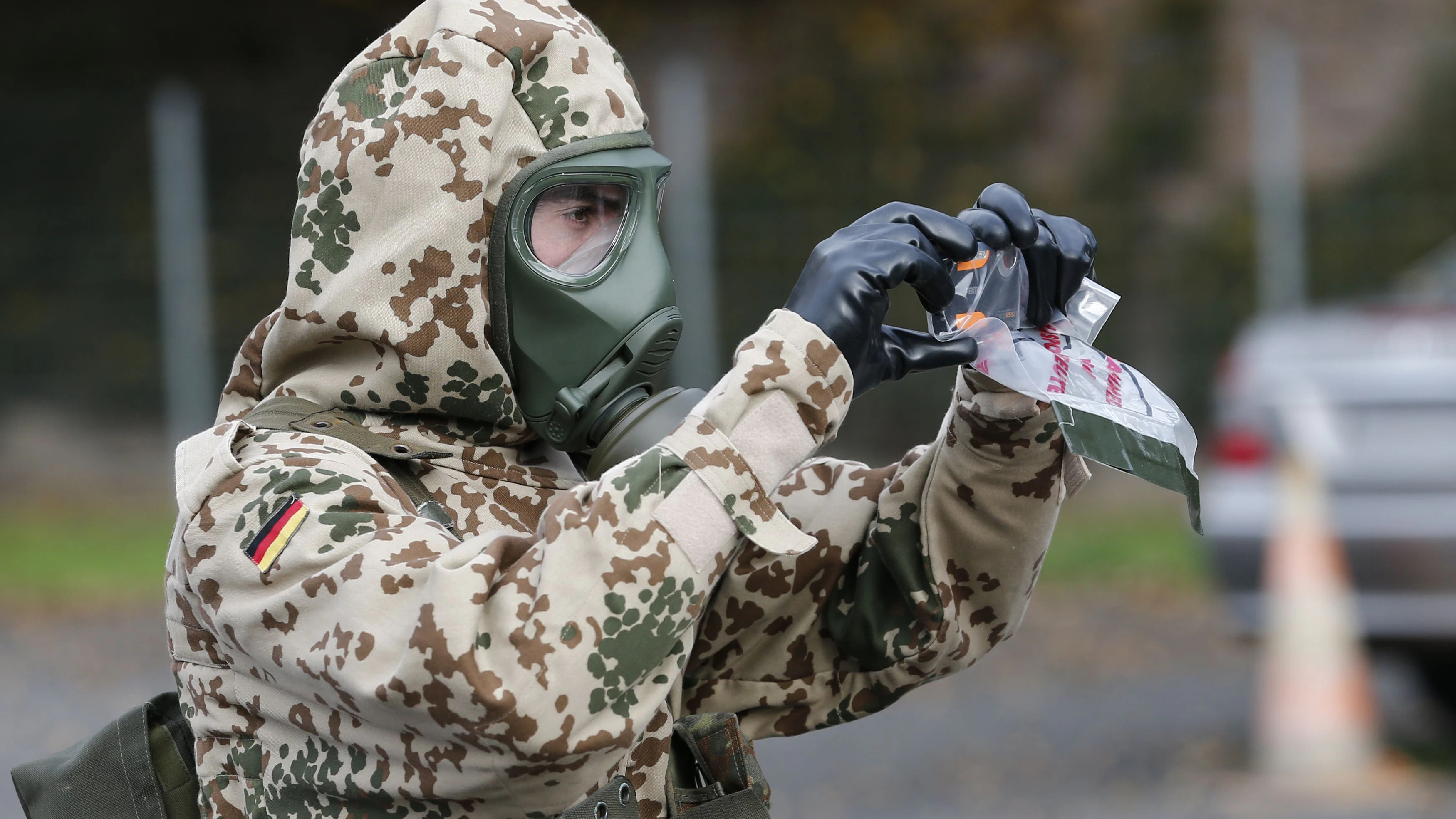 A German army soldier takes a picture of the working scene during the ABC FTX14 joined drill of the Swiss and German army Bundeswehr in Thonex near Geneva November 14, 2104.  Some 900 soldiers, including 130 from the Bundeswehr, train from November 10 to 20 with ten civil agencies on NBC (Nuclear, Biological and Chemical) and explosvies risks.     REUTERS/Denis Balibouse (SWITZERLAND  - Tags: MILITARY POLITICS)