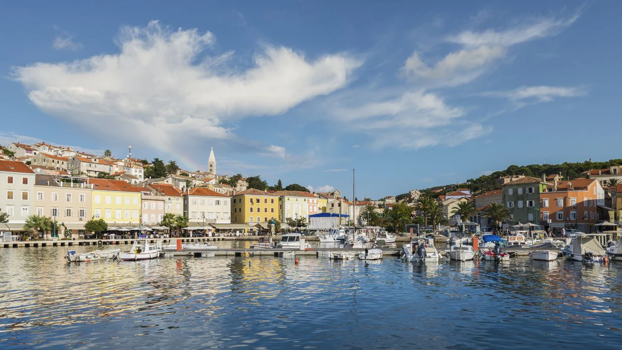 Sailing boats and yachts moored in the harbor of Mali Lošinj in the warm evening light, island Lošinj, Kvarner bay, Croatia
