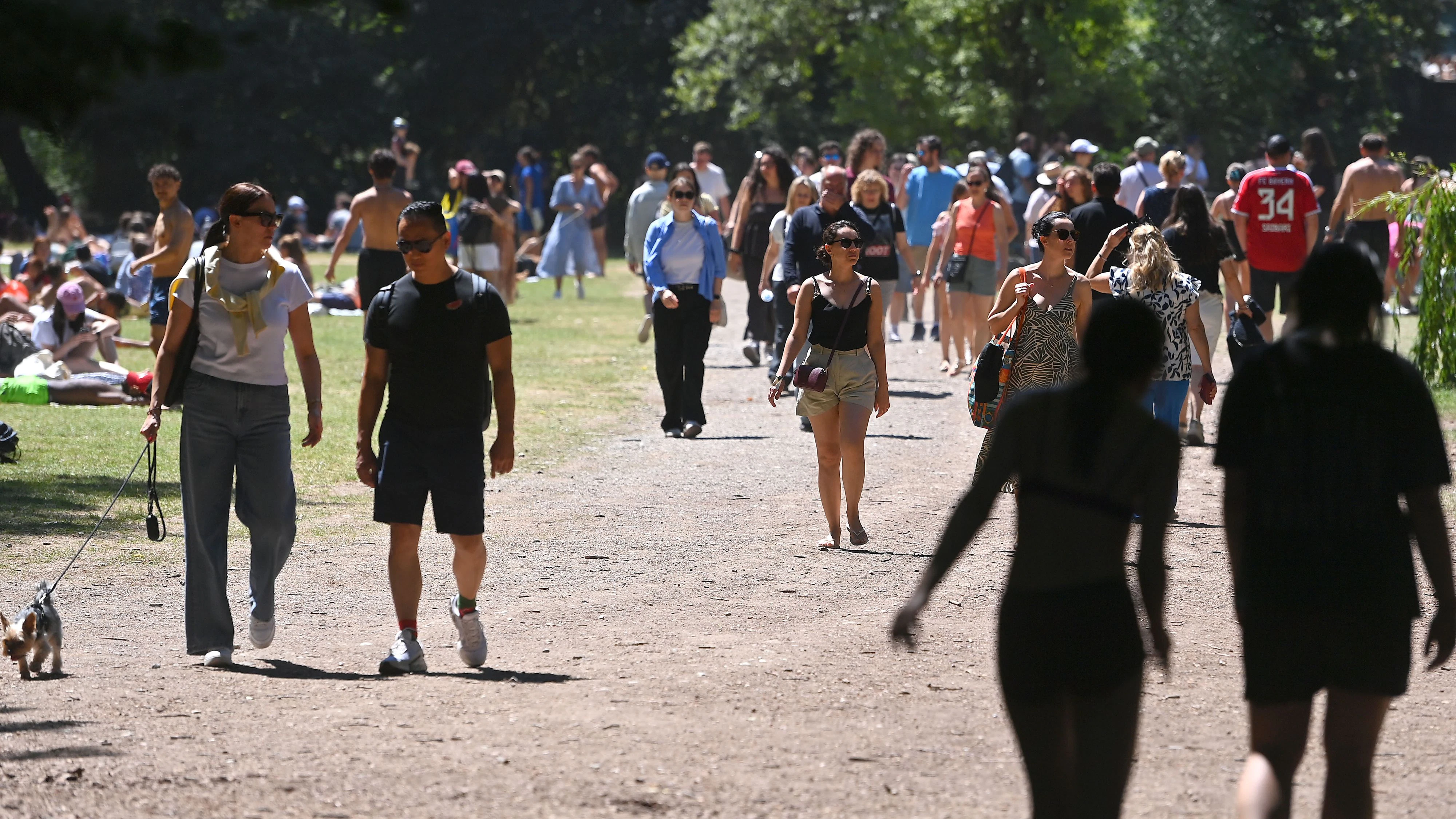 Weather picture from 12.07.2026 / People seeking cooling in the Eisbach in Munich. Best summer weather with temperatures around 30 degrees drives people in Munich to the open air in the English Garden ?SVEN SIMON Photo Agency GmbH & Co. Press Photo KG #