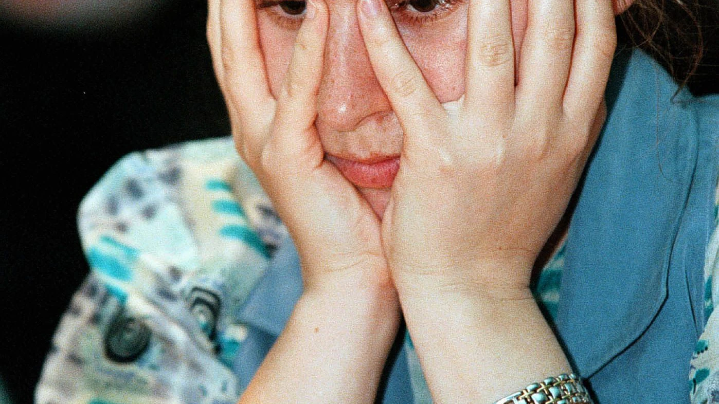 Hungarian women's world number one Chess player Judit Polgar cover her face as she plays a rapid game with [FIDE world chess champion Anatoly Karpov of Russia], during the exhibition  match in Budapest on June 11. [They play eight rapid games during the three-day tournament and  Polgar lead 3-1 after four games].