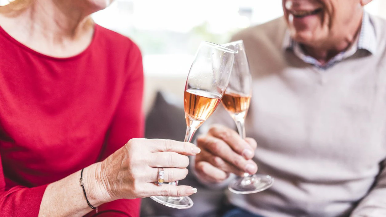 Senior couple celebrating with champagne