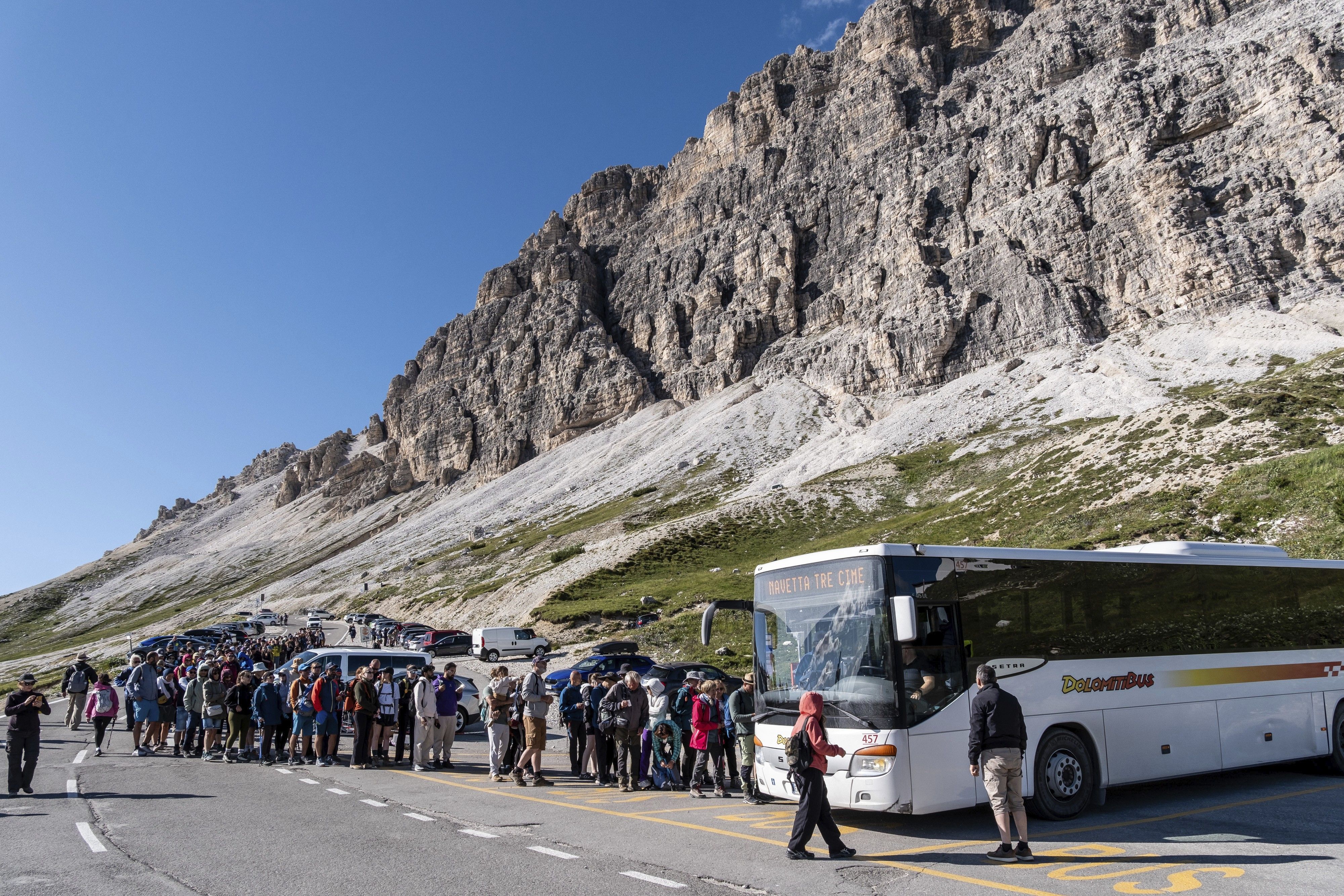 Hikers board the shuttle bus back from the Three Peaks