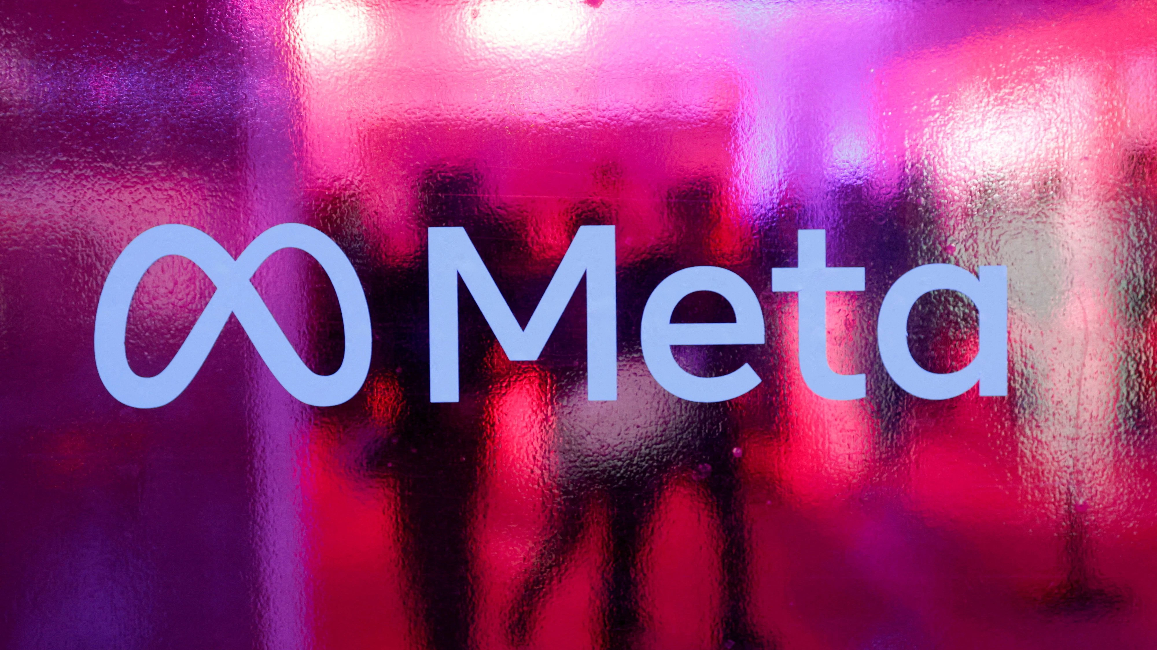 FILE PHOTO: People walk behind a logo of Meta Platforms company, during a conference in Mumbai, India, September 20, 2023. REUTERS/Francis Mascarenhas/File Photo