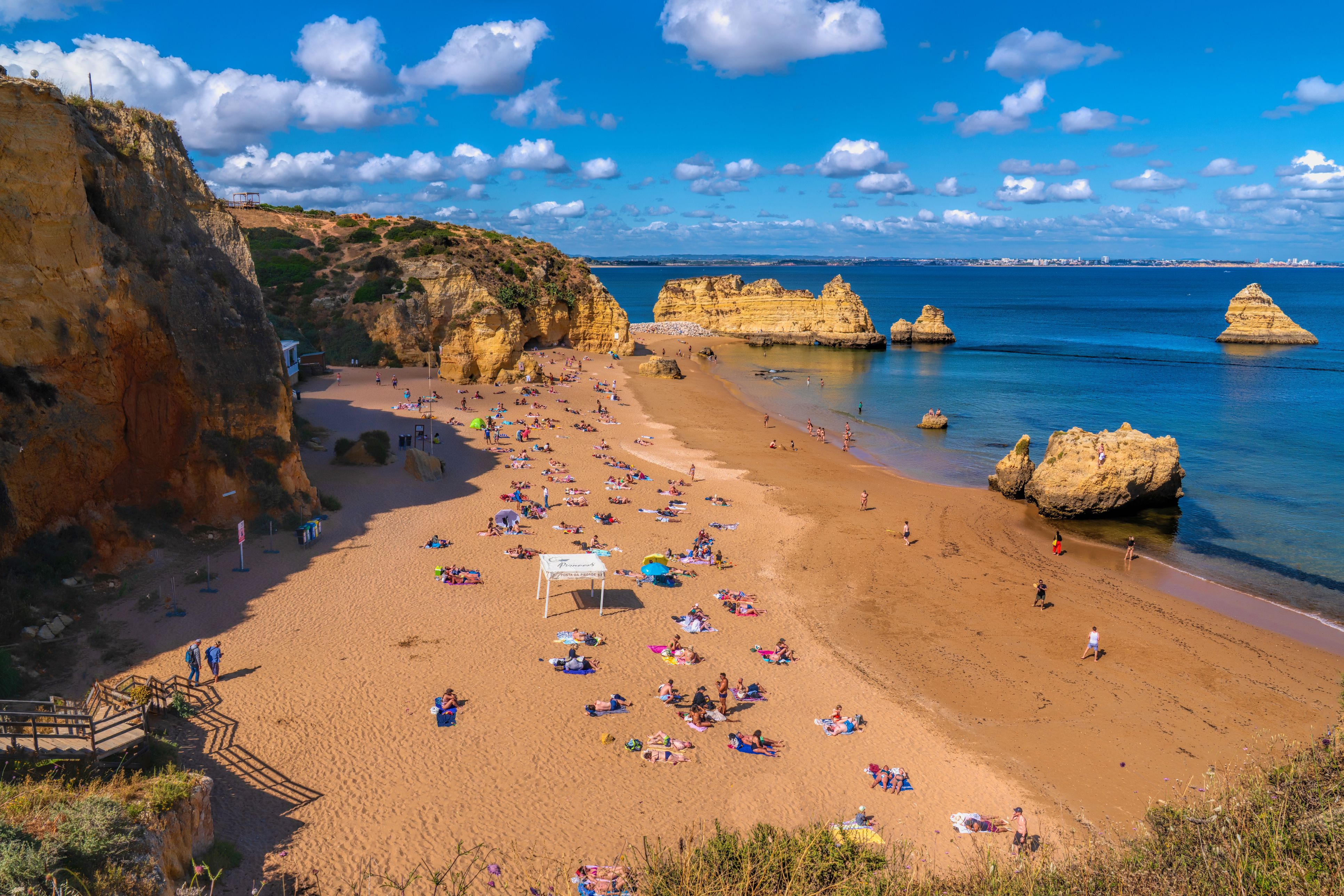 Praia Dona Ana beach with tourists and visitors enjoying the sunshine Lagos, The Algarve, Portugal on Saturday 20th May 2024